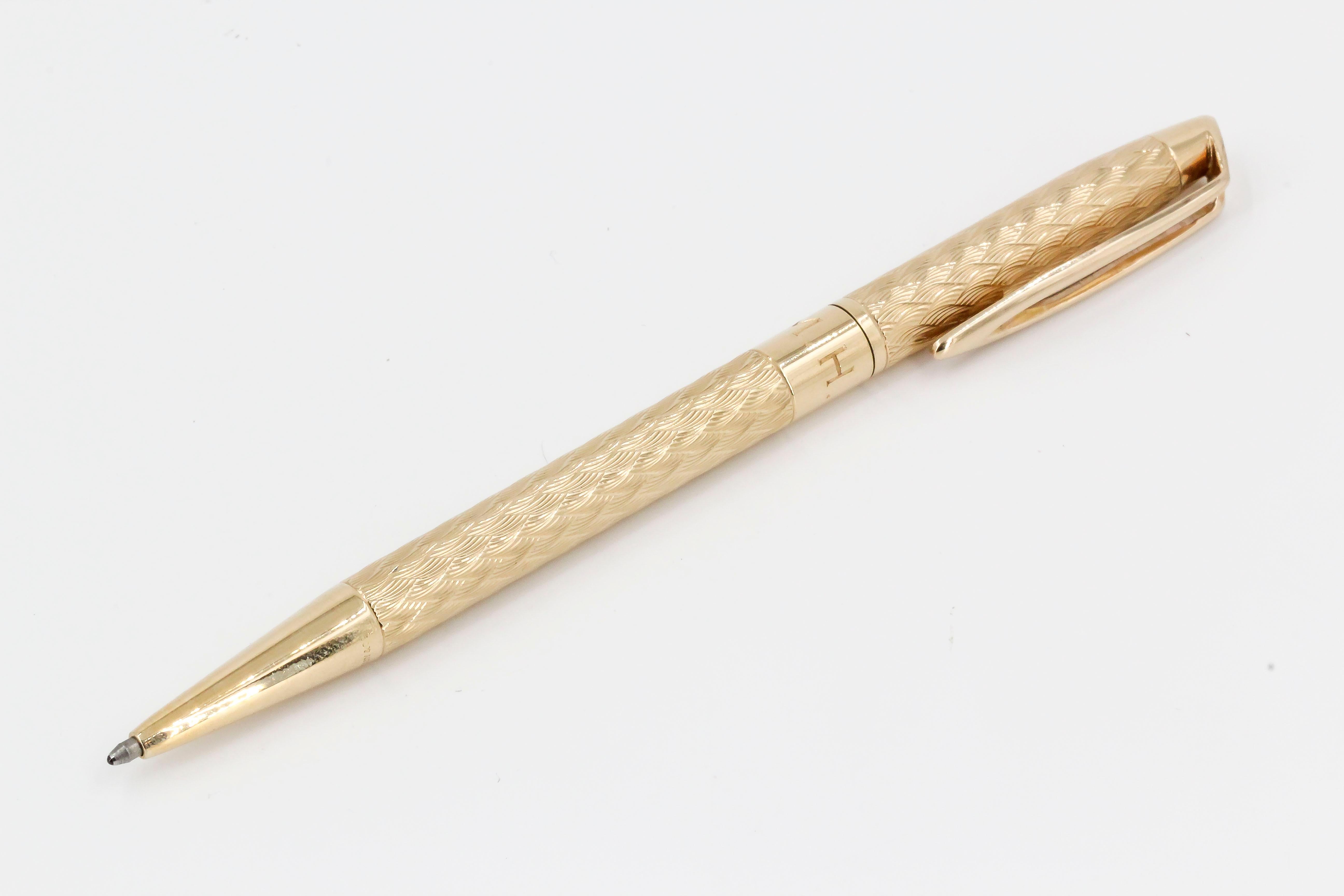Elegant 14k yellow gold mid-century engine turned ballpoint pen by Tiffany & Co., circa 1940s. Features initials 