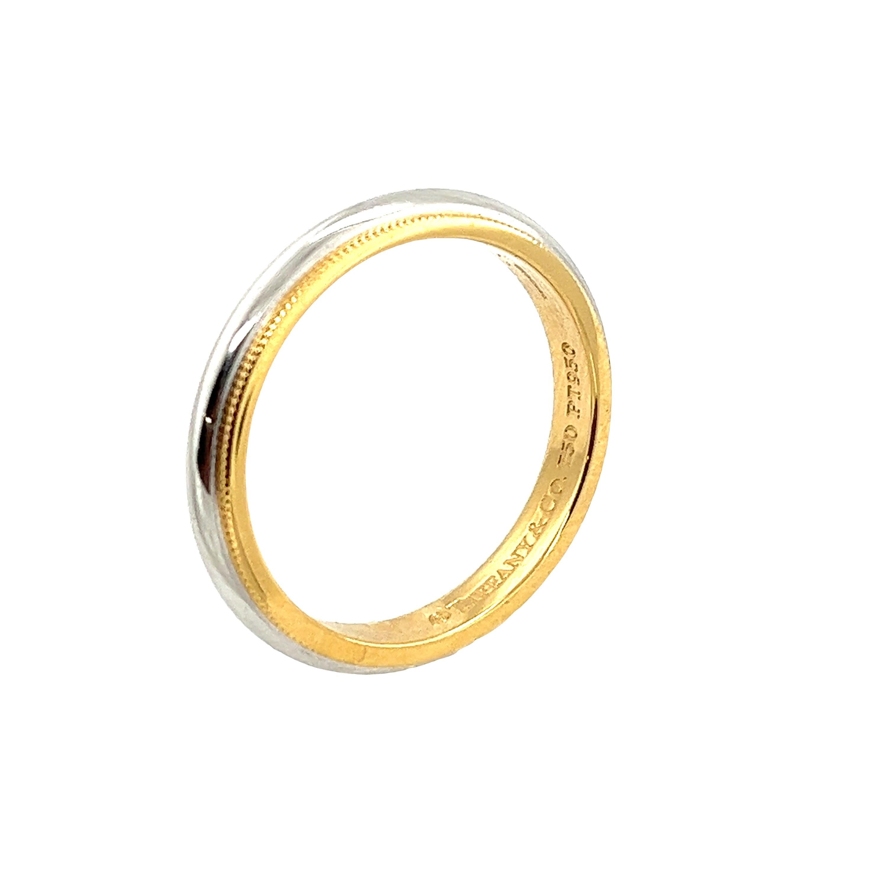 Celebrate everlasting love with the Tiffany & Co. Milgrain Two-Tone Wedding Band. Crafted from 18ct yellow gold and platinum, this 3.4mm band exudes timeless elegance. The delicate milgrain detailing adds a touch of sophistication, symbolizing the