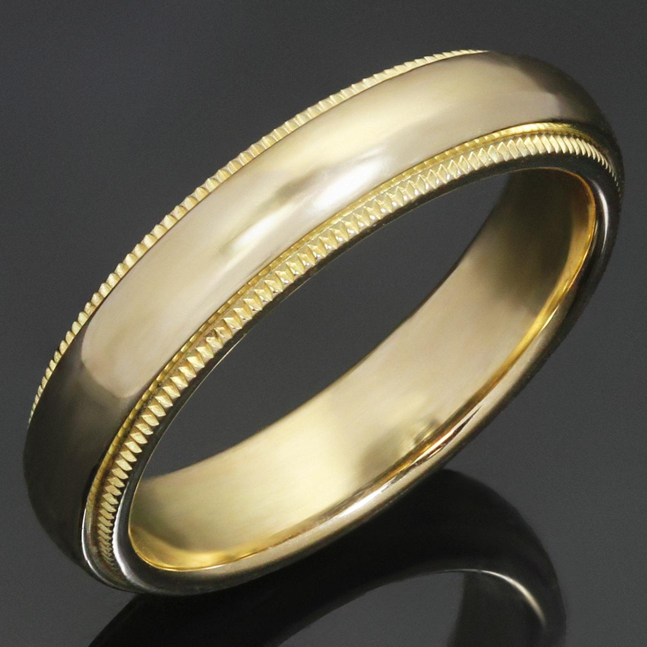 This timeless Tiffany wedding band ring features a classic milgrain design crafted in 18k yellow gold. Made in United States circa 2000s. Measurements: 0.15