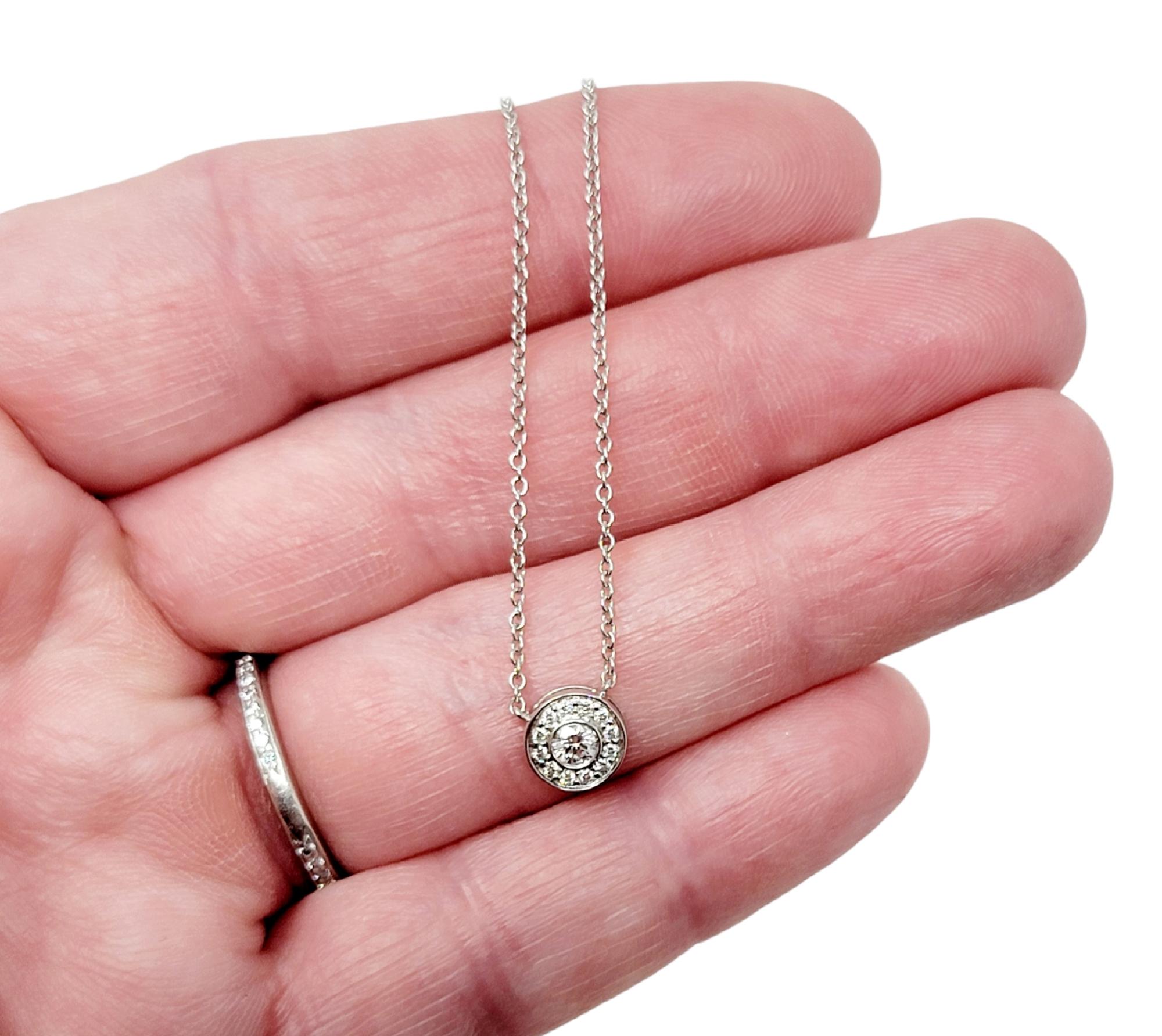 This diamond halo pendant necklace from Tiffany & Co. is stunningly simple, yet undeniably beautiful. Part of the Tiffany Circlet collection, the delicate platinum chain and icy circle of natural round diamonds goes with just about everything. It