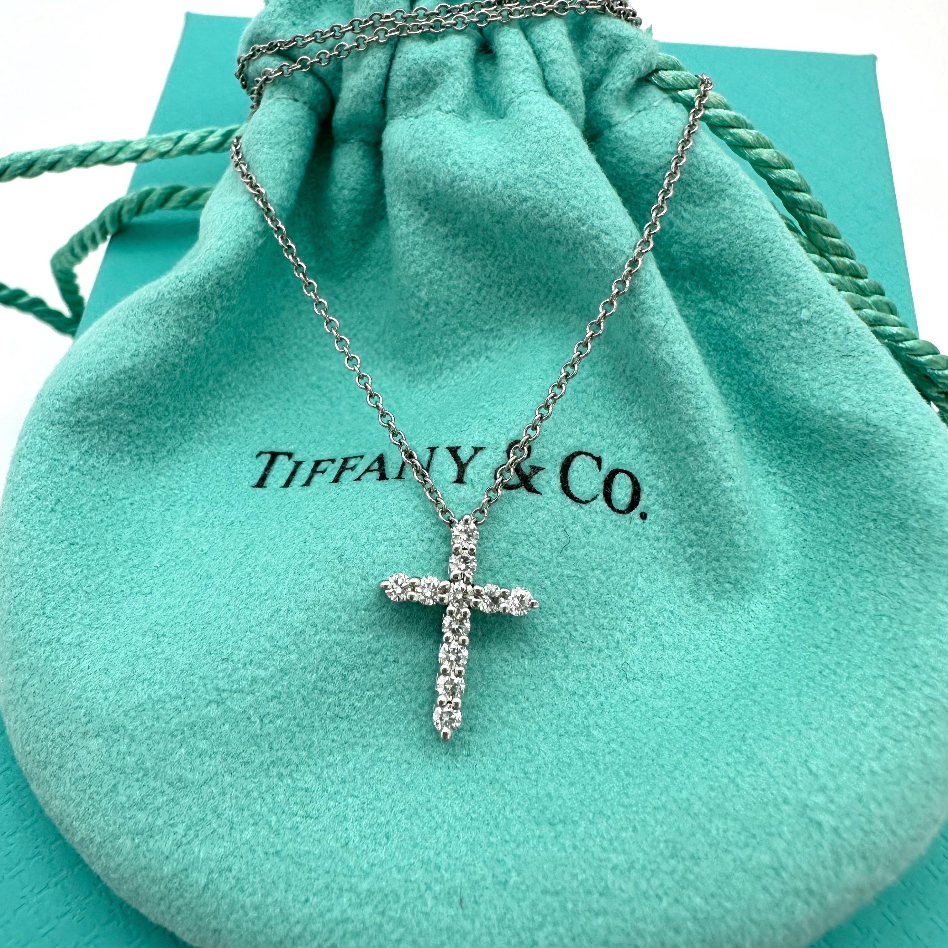 Tiffany & Co. Mini Diamond Cross Pendant Necklace
Style:  Pendant Necklace
Ref. number:  67124715
Metal:  Platinum PT950
Size:  Pendant 10 x 14 mm / Chain 16' Inches 
Diamonds:  11 Round Brilliant Diamonds 0.21 tcw White, Eye Clean 
Hallmark: 