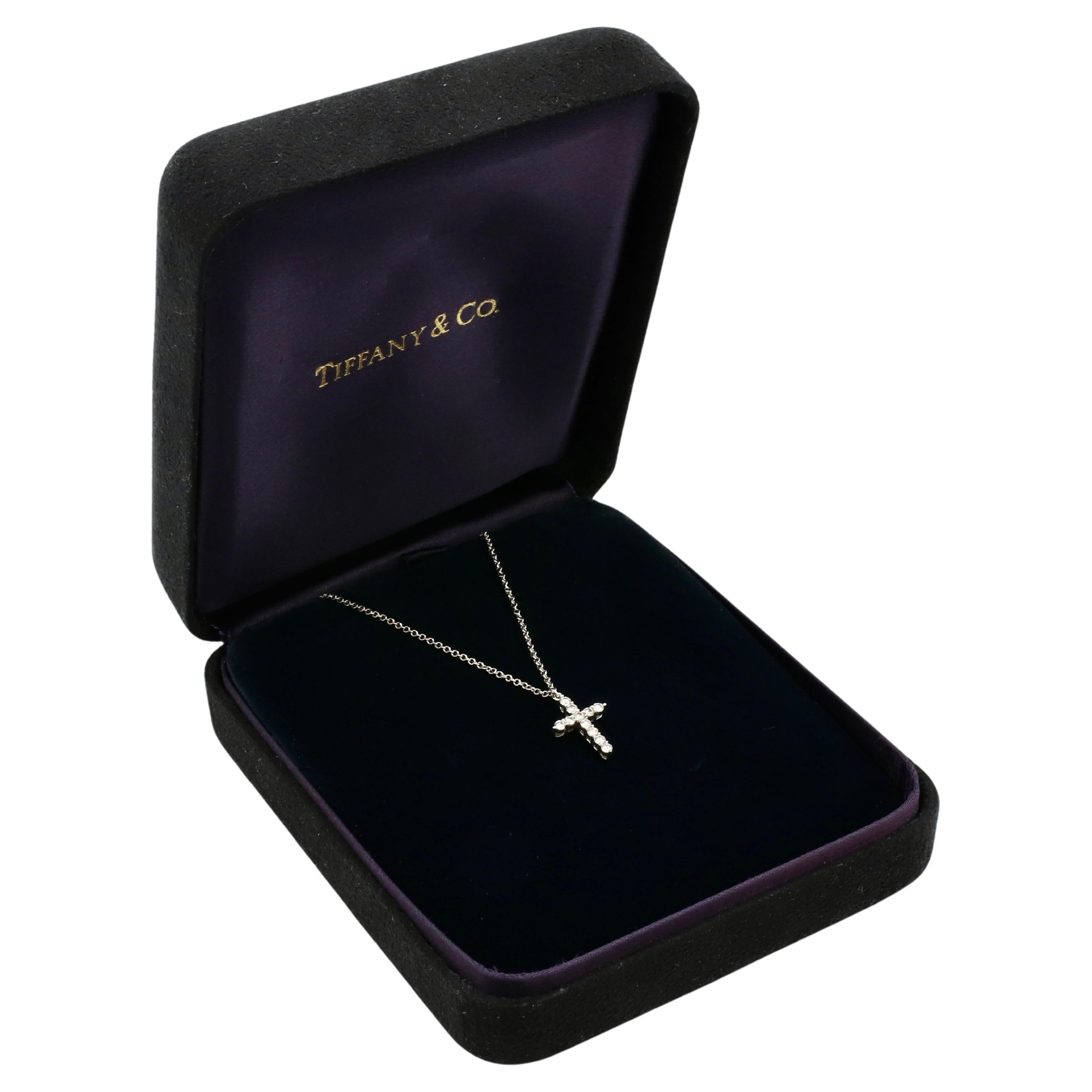 Tiffany & Co. Mini Natural Diamond Cross Pendant Necklace 
Metal: 18k white gold 
Diamonds: 0.21 CTW round F-G VS natural diamonds
Cross: 13.5 x 10mm
Chain: 20 inches
Weight: 2.48 grams
Signed: ©Tiffany & Co. Au750
Retail: $2500 USD (platinum