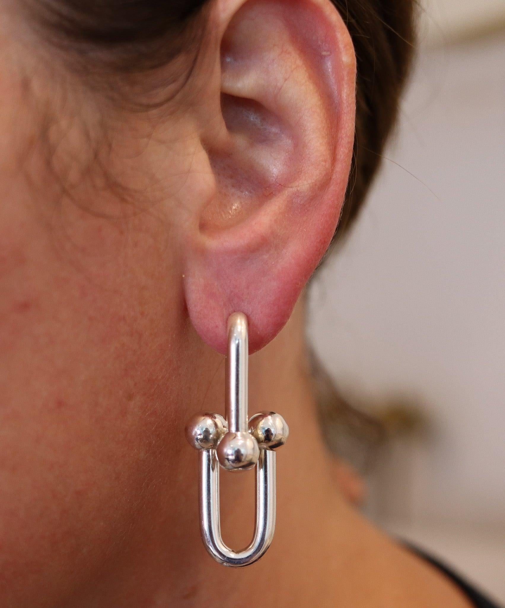 Hardware dangle earrings designed by Tiffany & Co.

This pair of dangles drop earrings is one of the ultimate most iconic pieces created by Tiffany & Co. They are part of the hardware collection and has been crafted with multiples graduated gauge