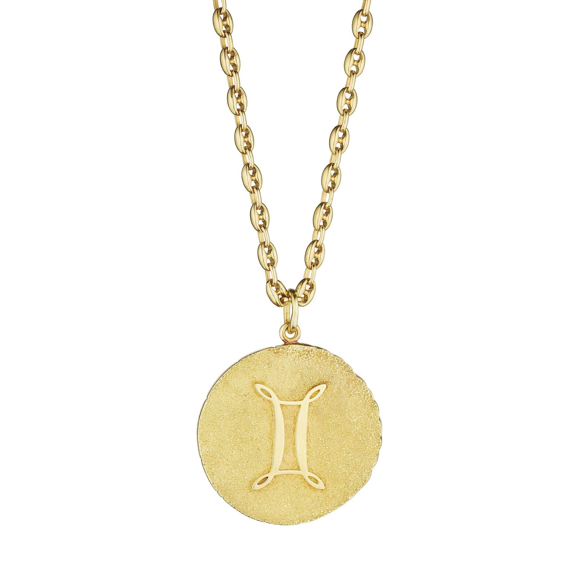 The zodiac symbol for Gemini is twins, and this modernist Tiffany & Co. pendant will keep you seeing double.  With a doubled faced front and the Gemini symbol on the back, this hefty 18 karat yellow gold circular pedant necklace proves that two is
