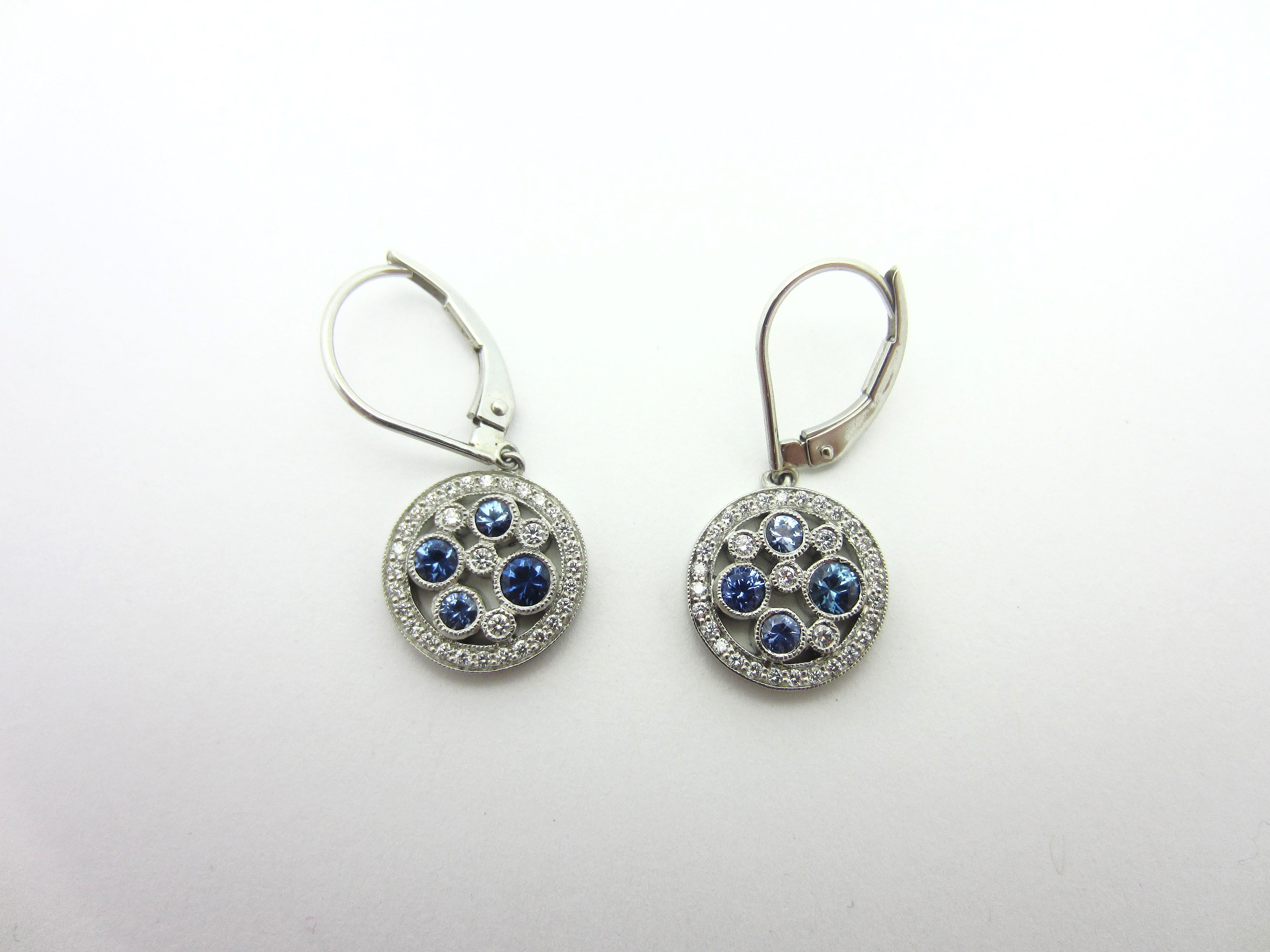 This gorgeous pair of platinum Tiffany & Co earrings is from the Cobblestone Collection.  They are set with approximately .50cttw of blue Montana sapphires and .17cttw of round brilliant diamonds.  The stones are set in millegrain-decorated bezels,