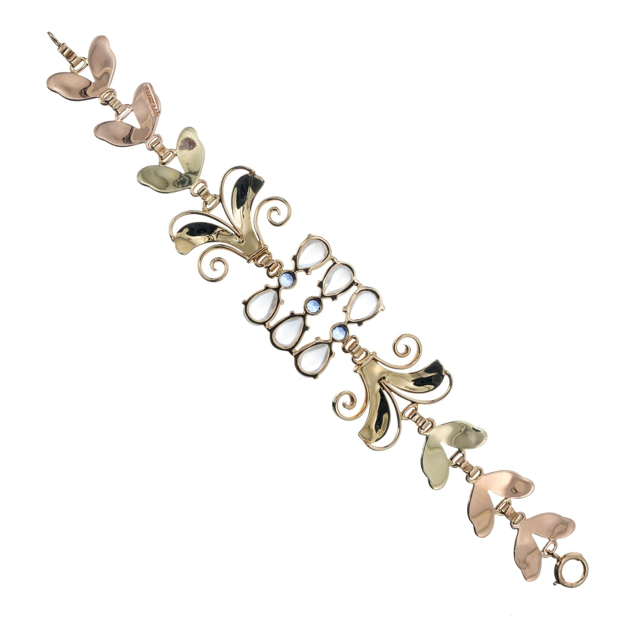 1940's Tiffany & Co rose and green gold Retro Art Deco sapphire and moonstone bracelet.  6 pear shaped Moonstones spaced by 3 round natural Montana Sapphires. 7.25 inches in length. 

14k rose and green gold 
3 round natural top gem blue Montana