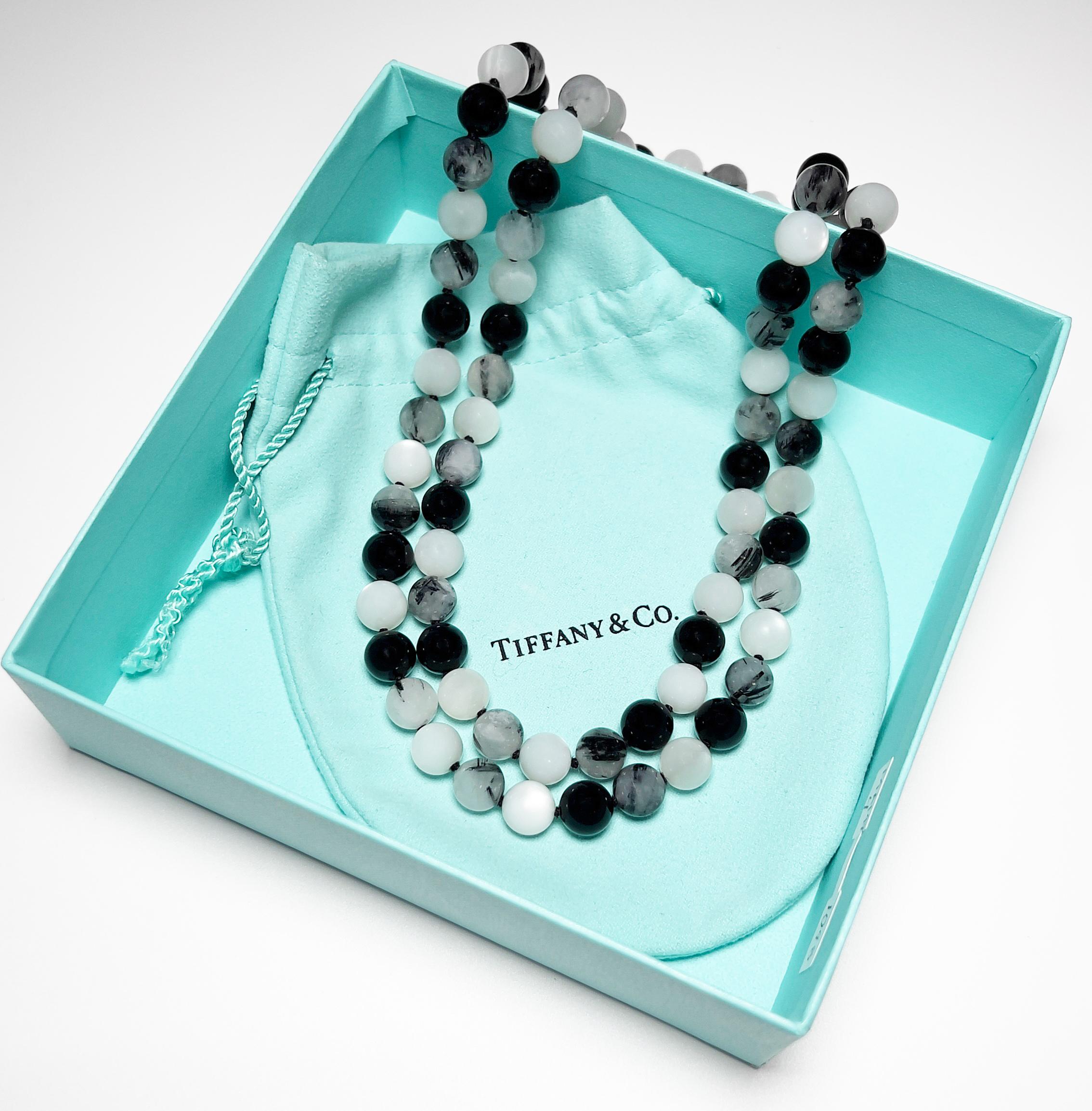 It comes with the Authenticity Certificate by GIA GG/AJP
Original Box and Pouch Included
Brand: Tiffany & Co.
Collection: Paloma Picasso
Gemstones: Moonstone, Onyx, Quartz
Cut: Round Beads
Diameter: 10 mm
Metal: Silver
Necklace Length: 36 inches