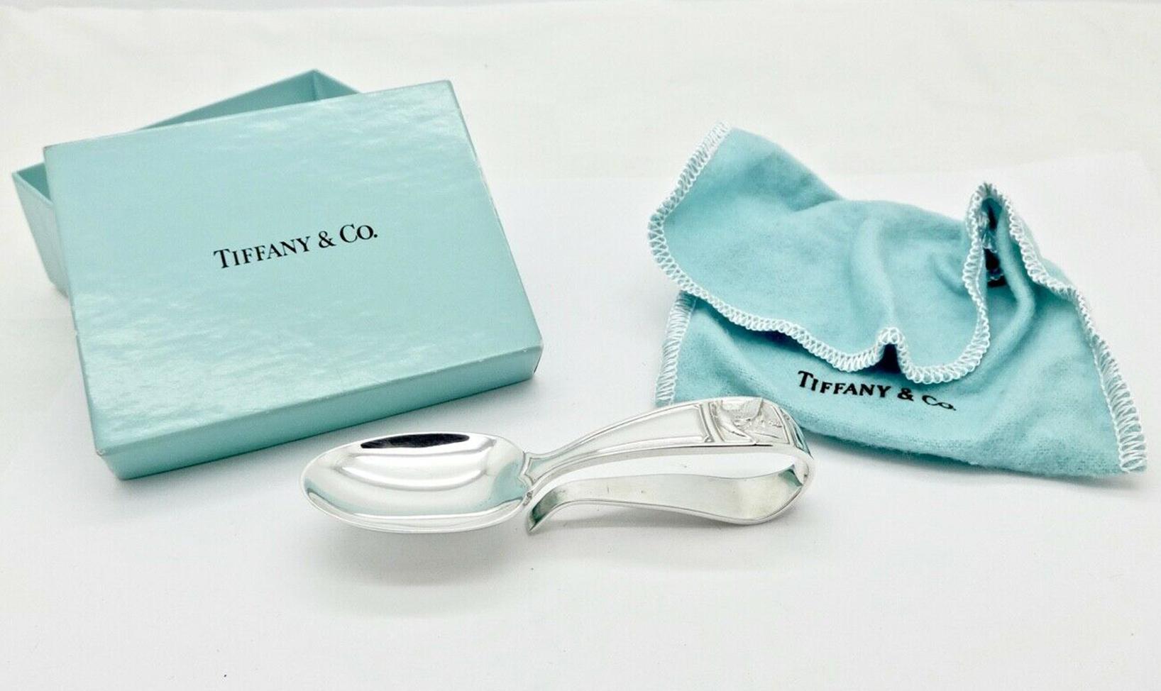 Tiffany & Co. sterling silver mother goose curved handle baby feeding spoon with original pouch and box. Approximate size 3.75