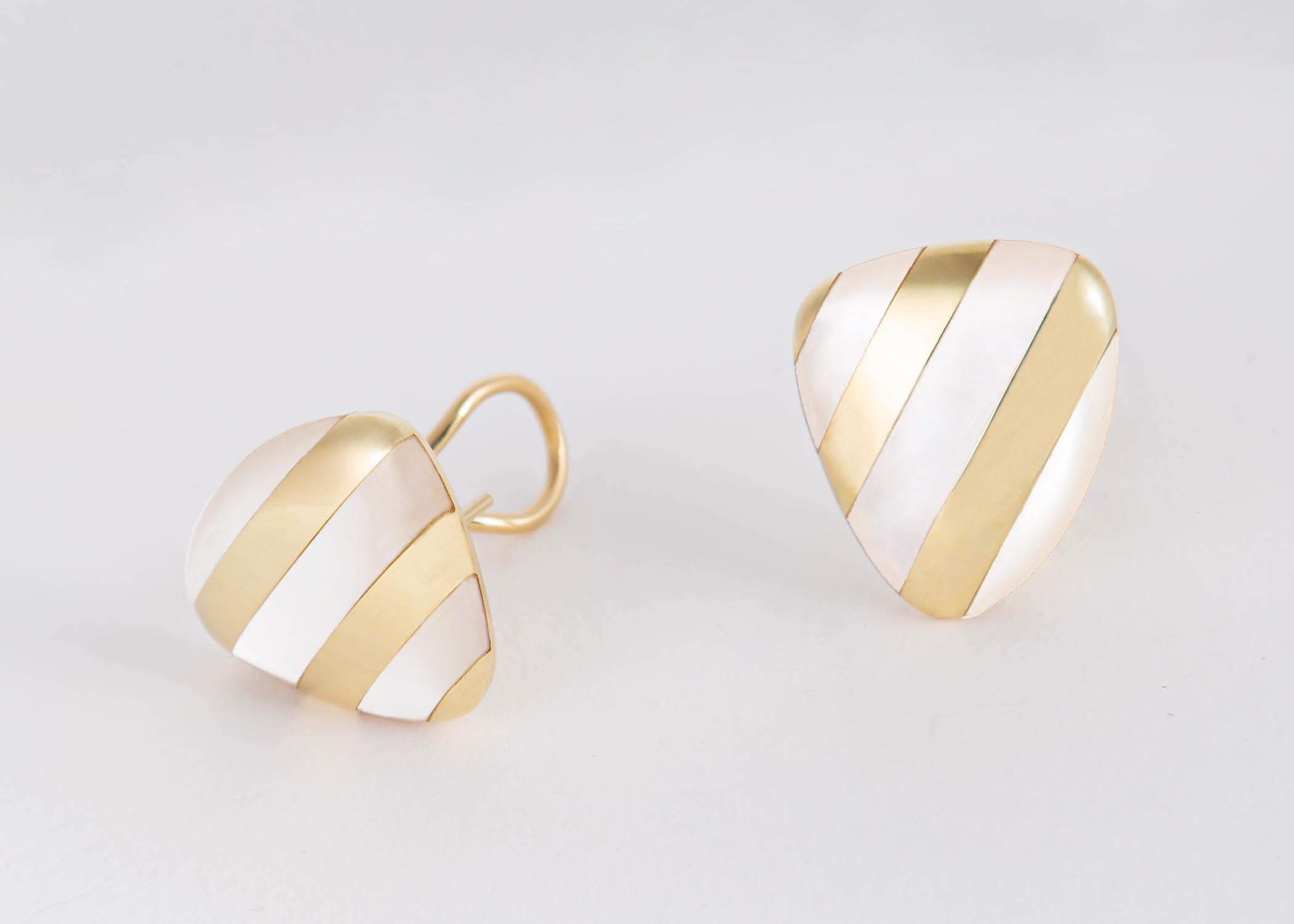 Tiffany & Co. combines beautiful mother of pearl and rich 18k gold to create this simple chic classic. 7/8's of an inch in size.