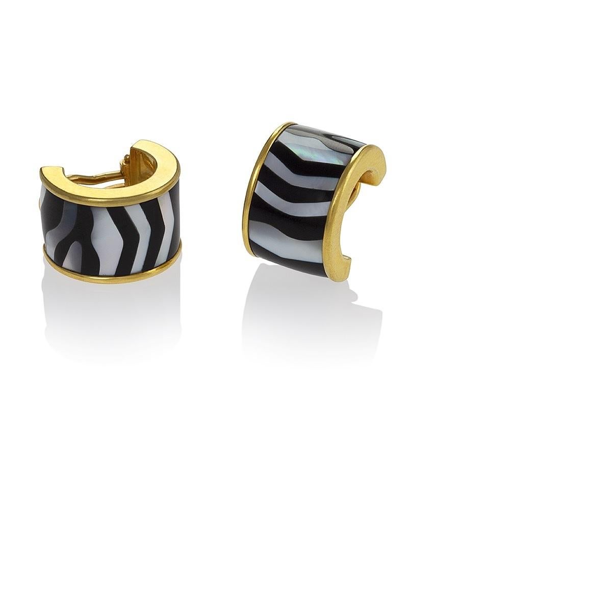 A pair of Estate 18 karat gold earrings with mother of pearl and black jade by Tiffany & Co. The hoop earrings have alternating irregularly sectioned mother of pearl and black jade strips. Circa 2000.

Signed, 
