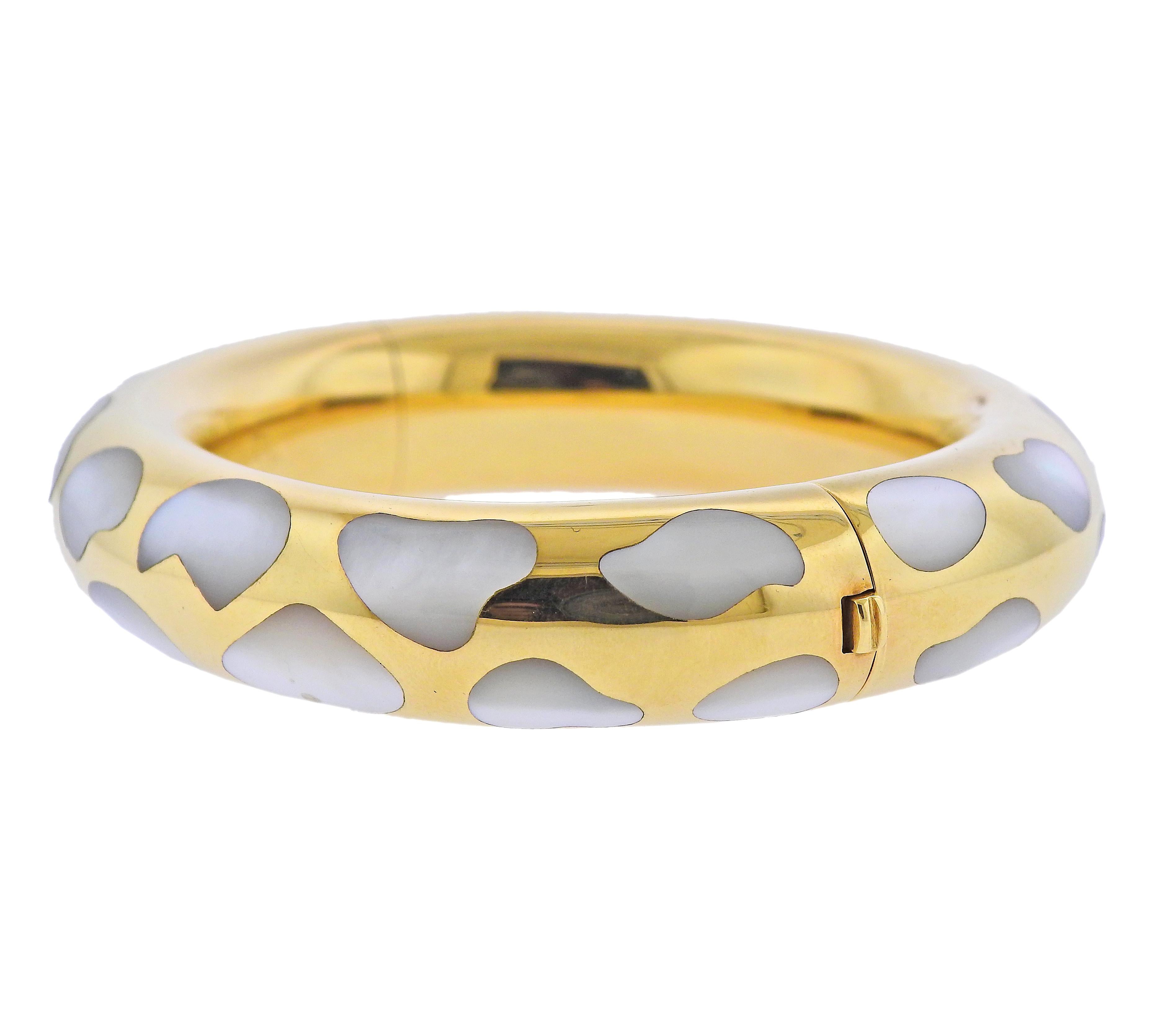 18k yellow gold bangle bracelet by Tiffany & Co, with mother of pearl inlay. Bracelet will fit up to 7.25