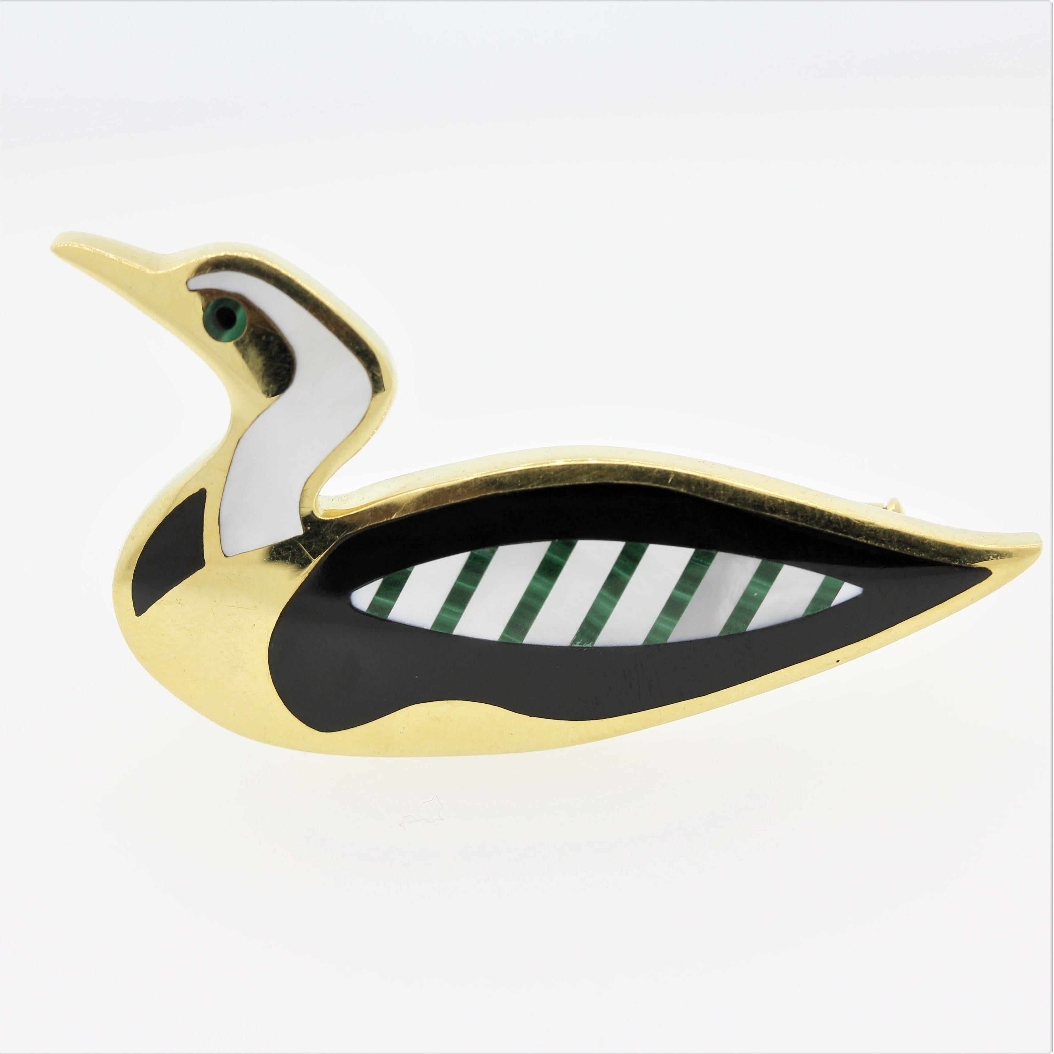 An original piece by Tiffany & Co, this duck pin features fine inlaid stones. They include mother of pearl which make up the duck’s neck and wing, black onyx marking its chest and side and green malachite that strips its wing and eye. A sweet and
