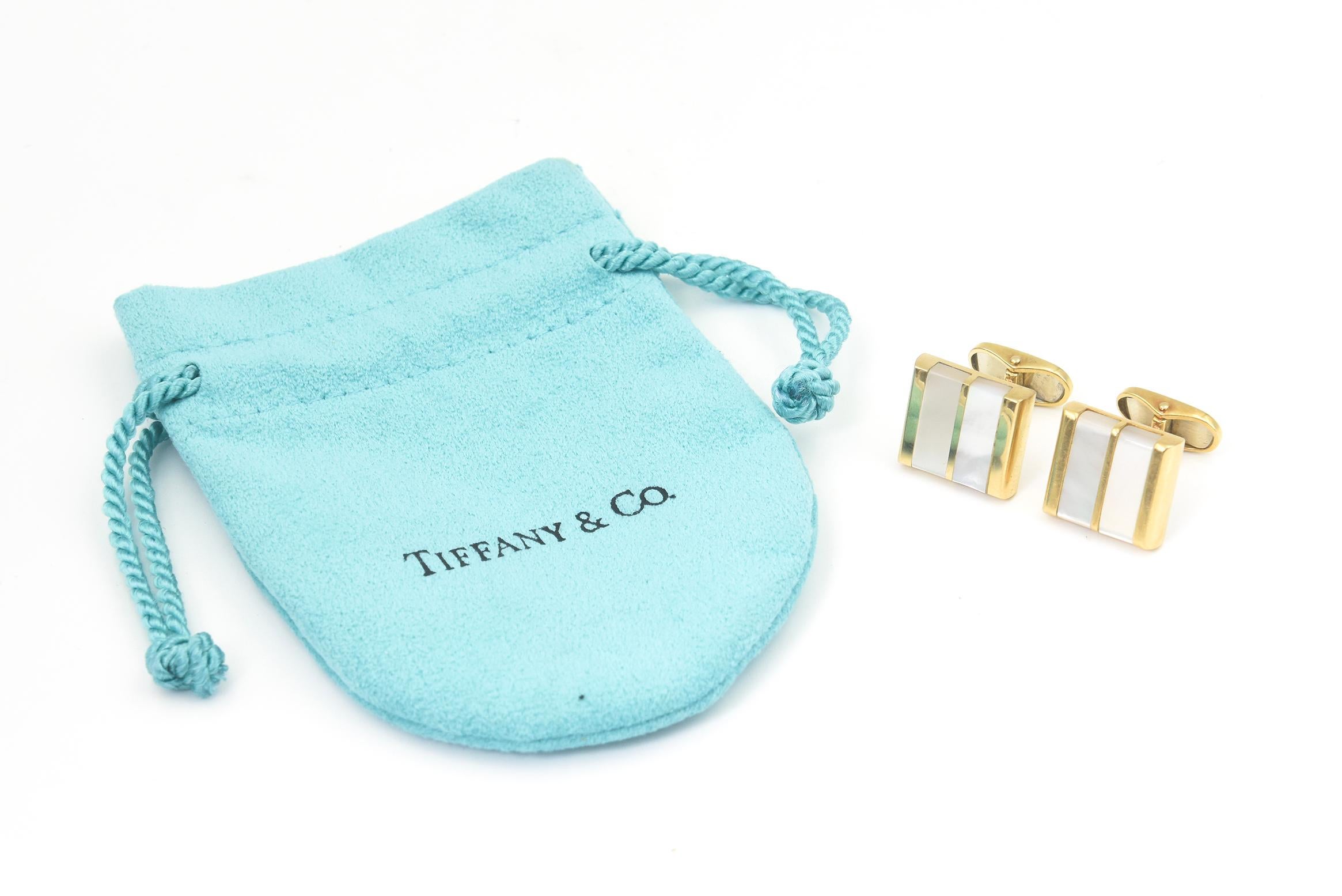 Tiffany & Co. mother of pearl and 18k yellow gold cufflinks featuring a square design with 2 rectangular inset mother of pearl pieces.  Foldable back makes it easy to get on.  Marked Tiffany & Co. 18k.