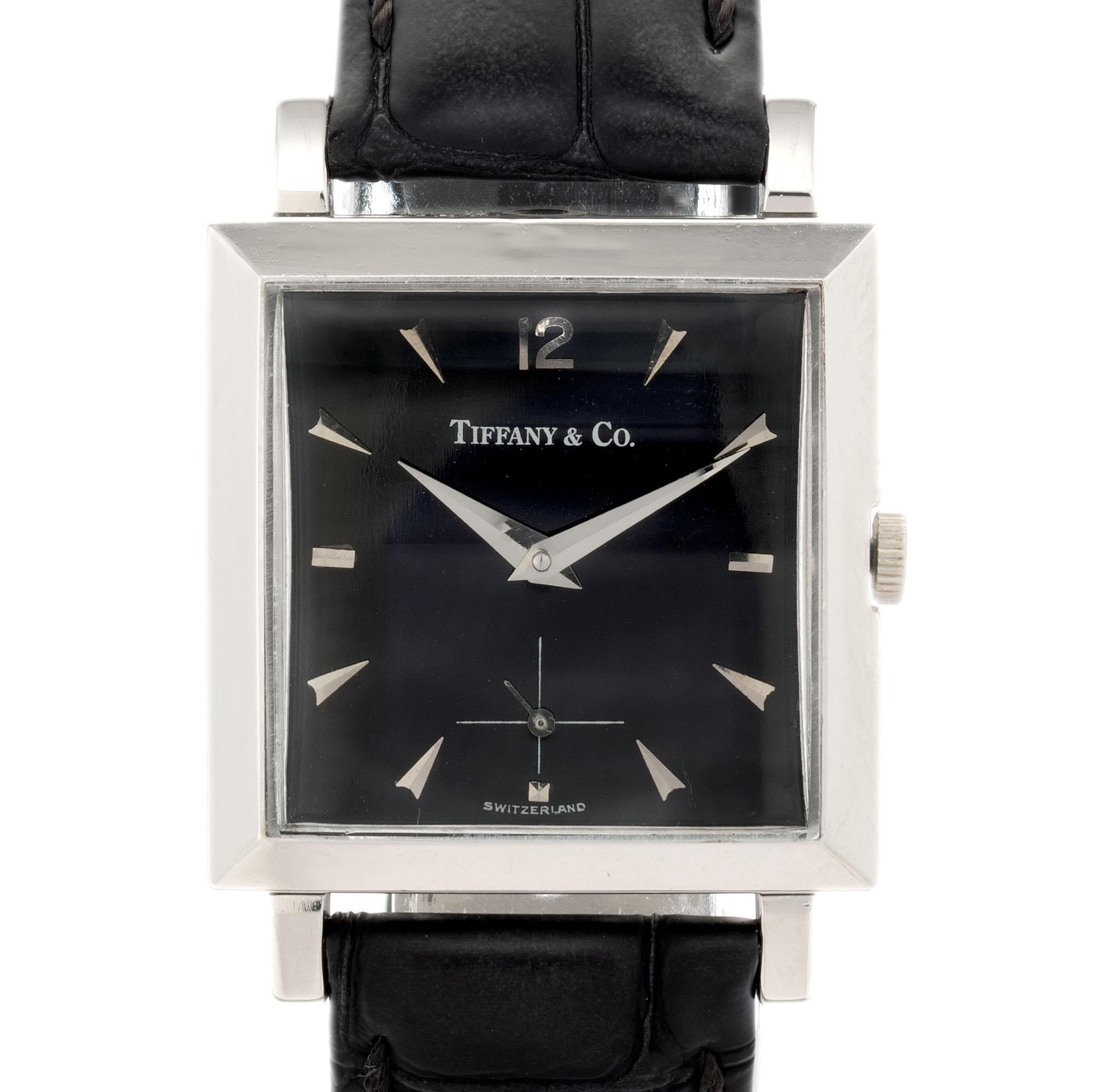  1960’s black dial, Rectangular Tiffany & Co Movado strap wristwatch with Movado 0309 manual wind 17 jewel movement. 

Length: 38.8mm
Width: 28.2mm
Band width at case: 18mm
Case thickness: 9.41mm
Band: Black genuine leather
Dial: Black silver