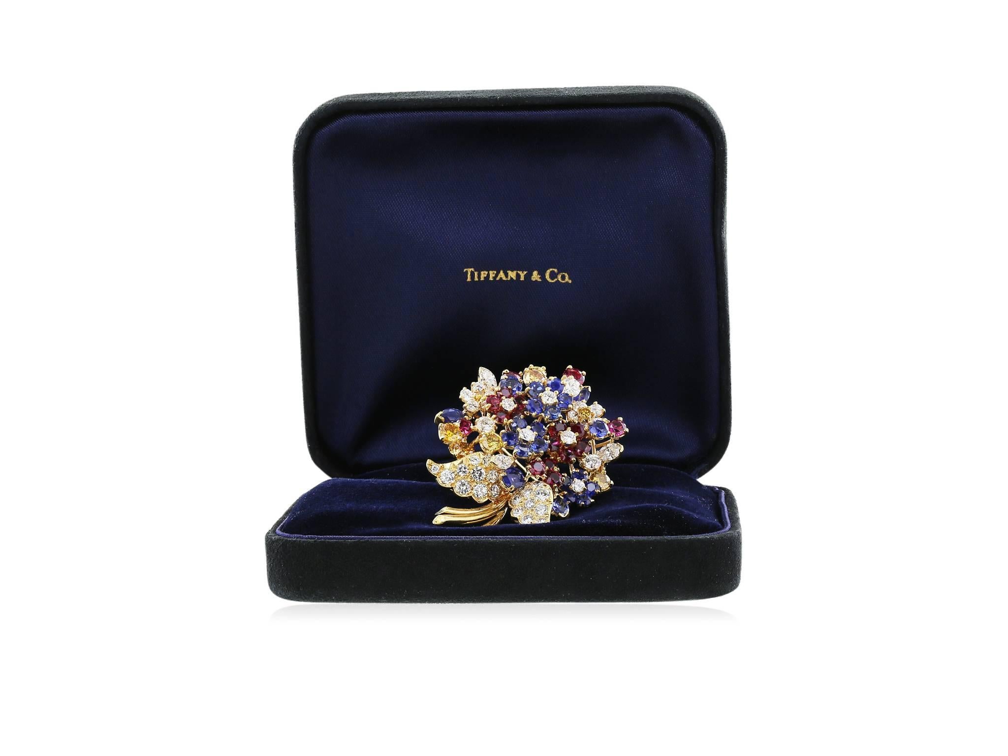 !8 karat yellow gold multi gem floral love knot pin consisting of diamonds, rubies, sapphires and canary diamonds, with a total approximate weight of 14 carats, signed, Tiffany & Co. with original box.