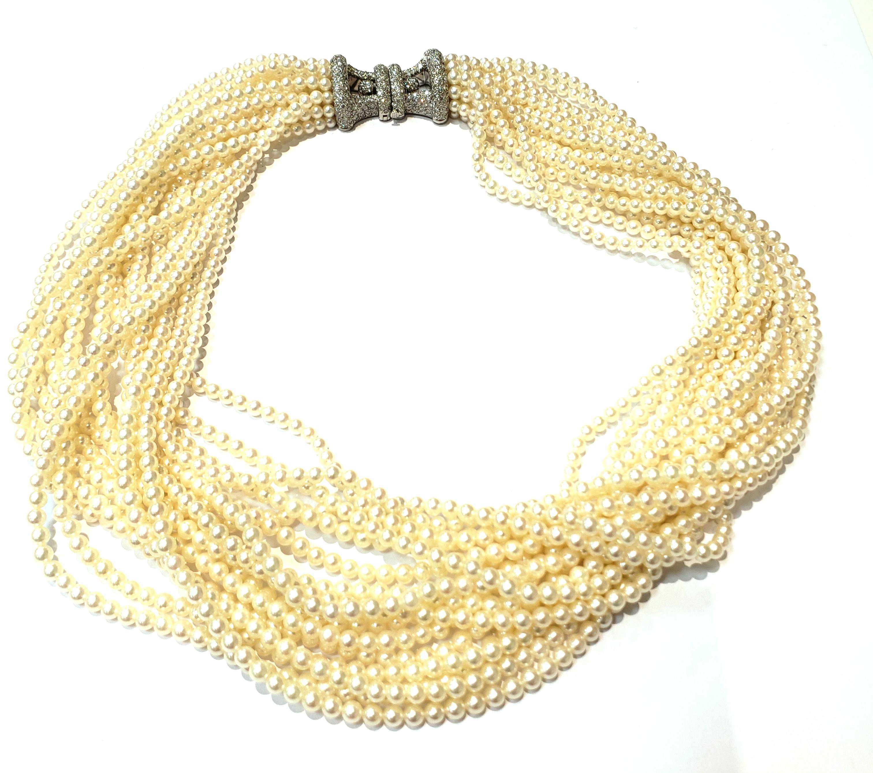 A Multi Strand Pearl Choker Necklace By Tiffany & Company, With A Pave Diamond Clasp, Set In Platinum.
Twelve Strands of 3.5 Millimeter Cultured Pearls. Clasp Has An Open Design & Is Fully Paved, With A Fold Over Safety Clasp.
Clasp Is Stamped