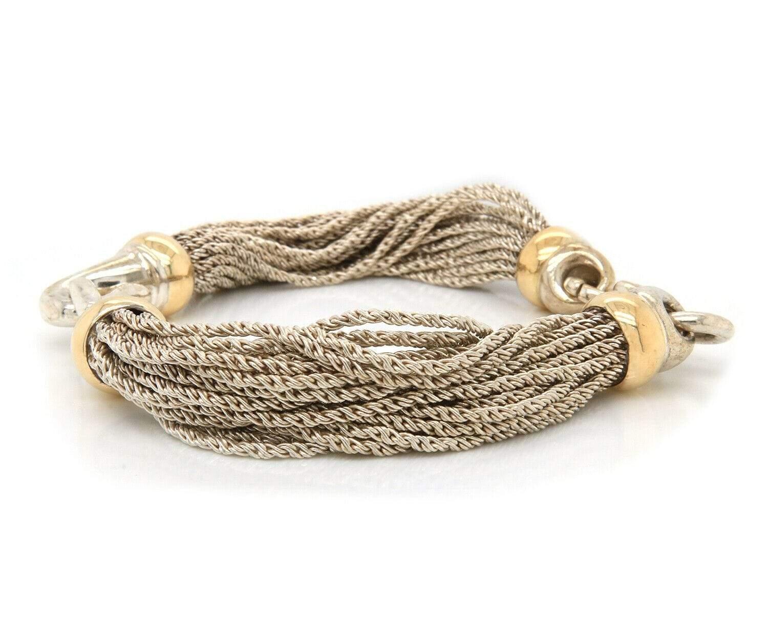 Tiffany & Co. Multi Strand Two Tone Bracelet in 18K and Sterling

Tiffany & Co. Multi Strand Two Tone Bracelet
18K Yellow Gold
Sterling Silver
Bracelet Width: Approx. 10.0 – 12.0 MM
Bracelet Length: Approx. 7.5 Inches
Weight: Approx. 50.20