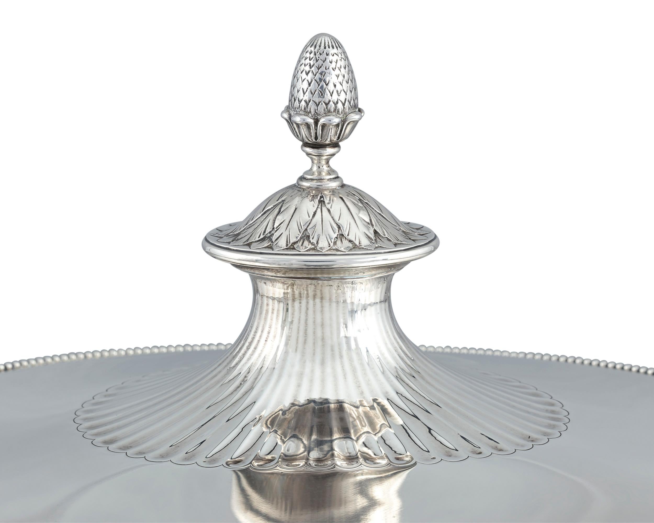 Tiffany & Co. displays its design prowess with this exquisite silver soup tureen. The firm's reinterpretation of the Neoclassical style, which was pioneered by such silversmithing legends as Paul Storr and Hester Bateman, is flawless. The footed
