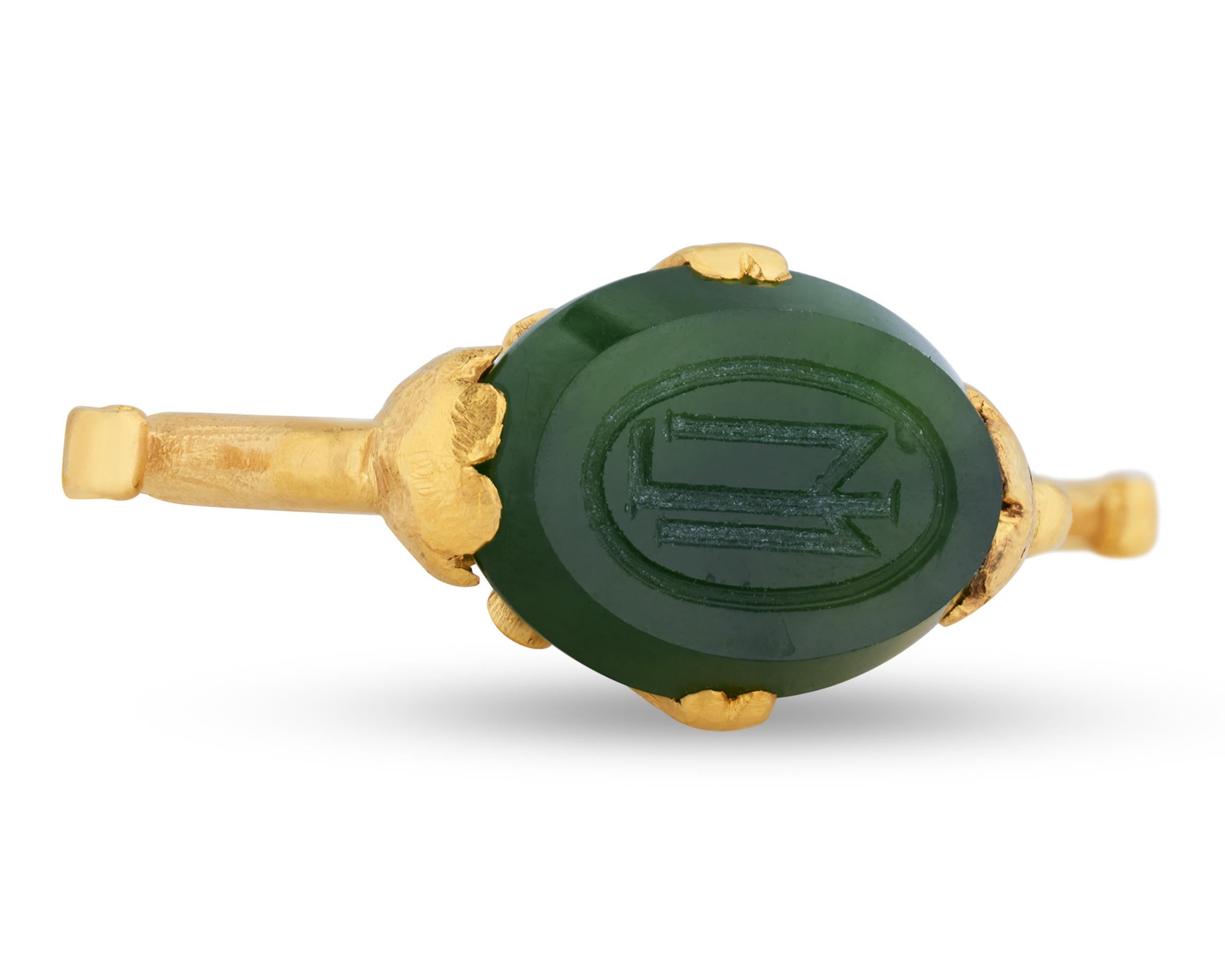 This inventive nephrite jade pendant crafted by famed jeweler Tiffany & Co. possesses the dual function as both a dazzling piece of jewelry and a seal. The verdant green specimen is incised with the letters 