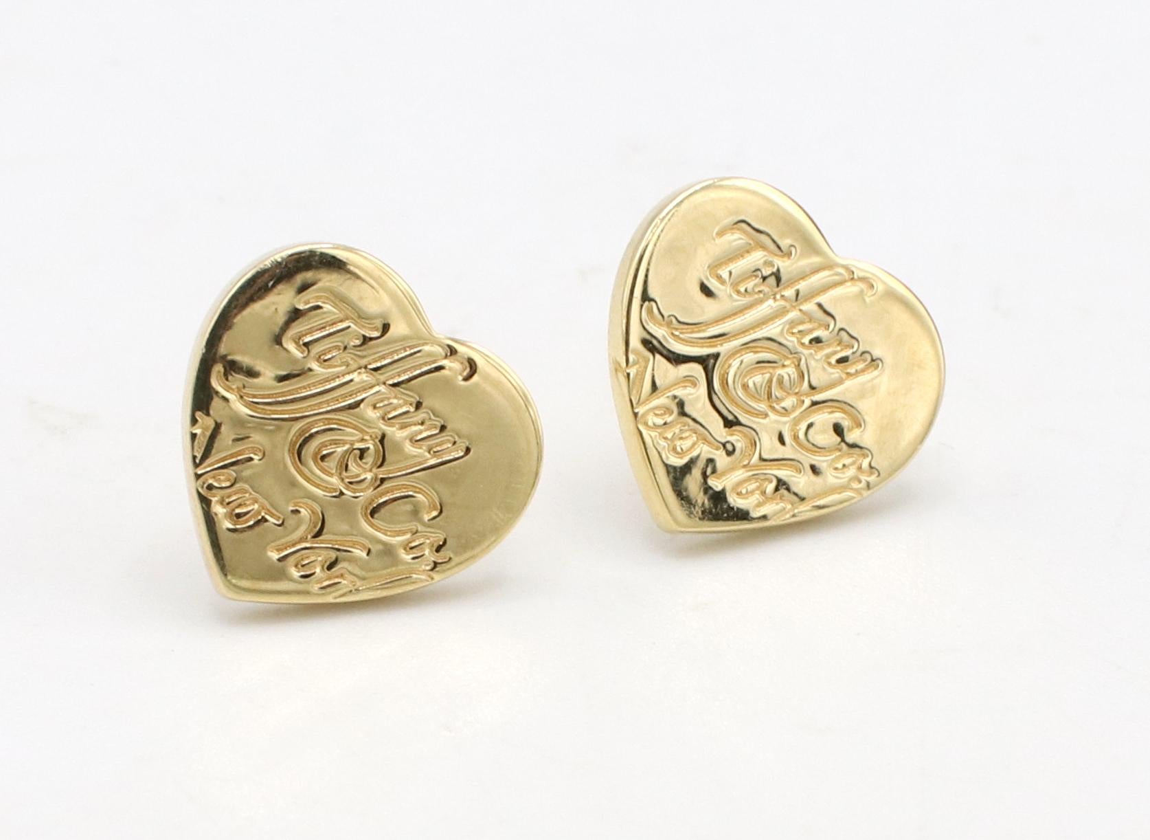 Tiffany & Co. New York Notes 18 Karat Yellow Gold Heart Logo Stud Earrings 
Metal: 18k yellow gold
Weight: 3.25 grams
Dimensions: 10 x 9.5mm
Backs: Push backs
Note: Push backs are original Tiffany & Co but slightly different sizes. An additional