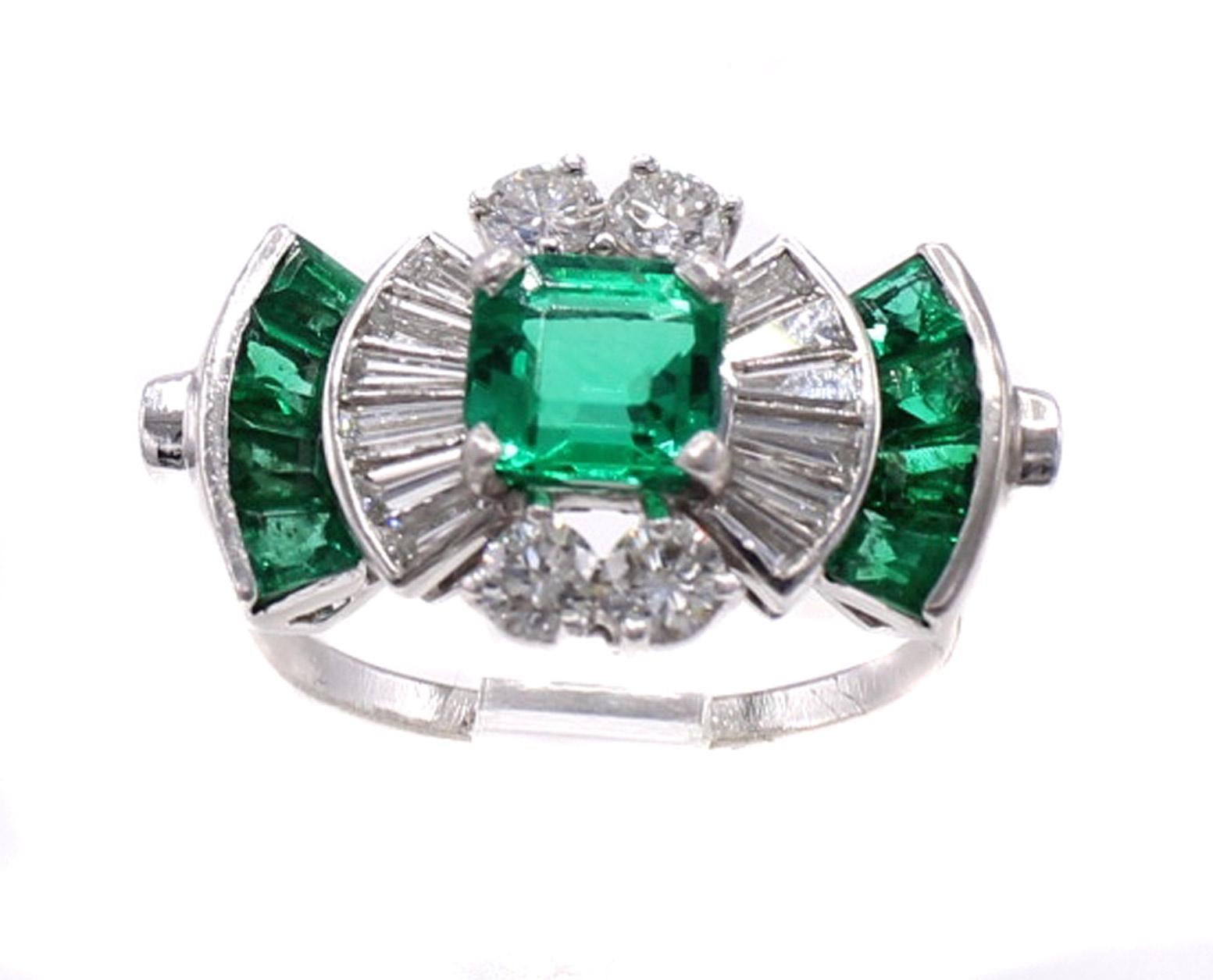 Beautifully designed and masterfully handcrafted in platinum by Americas most renown jeweler Tiffany & Co , this 1940s Retro ring displays a wonderful contrast of colors. The centerpiece of this amazing ring is a Colombian square step cut emerald