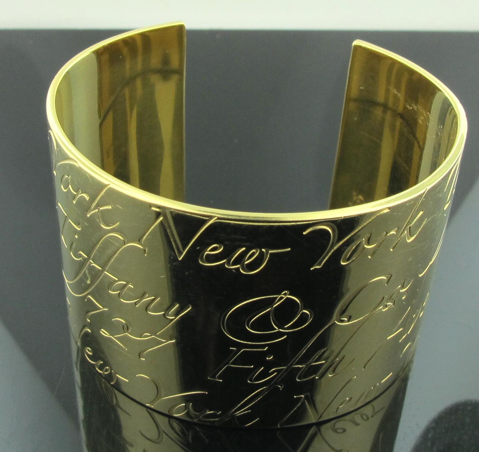 Signed Tiffany & Company 18 karat yellow gold Notes cuff.  Cuff is 40 mm.  Etchings in script include 