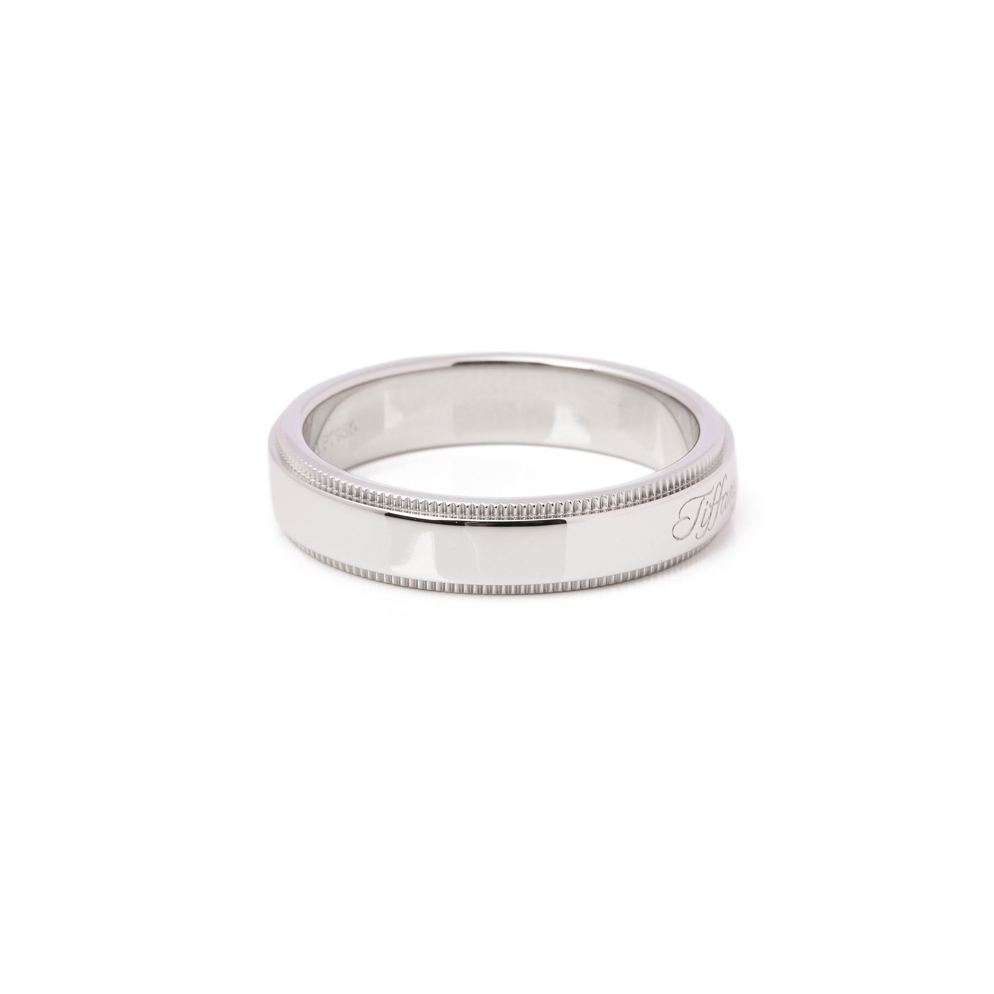 This ring by Tiffany is from their Notes collection and features a Tiffany & Co inscription along the outer band along with a milgrain edging. Set in a platinum band ring. UK ring size L. EU ring size 51. US ring size 5 3/4. Complete with Tiffany