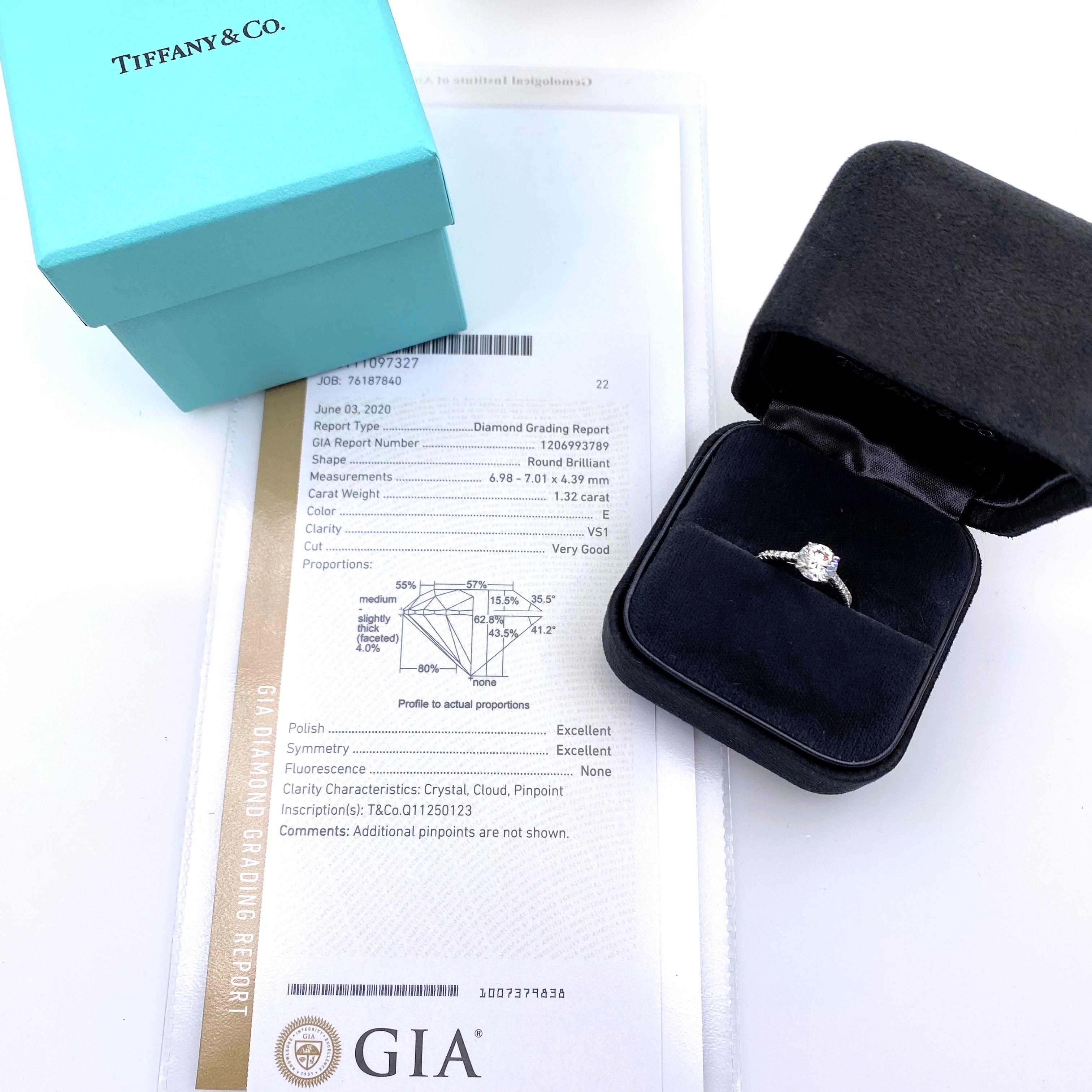 Tiffany & Co.
Style:  Novo Engagement Ring
Metal:  Platinum PT950
TCW:  1.62 tcw
Main Diamond:  Round Brilliant 1.32 cts
Color & Clarity:  E - VS1
Accent Diamonds:   20 Round Brilliant Diamonds 0.30 tcw F - G color, VVS clarity
Hallmark: 