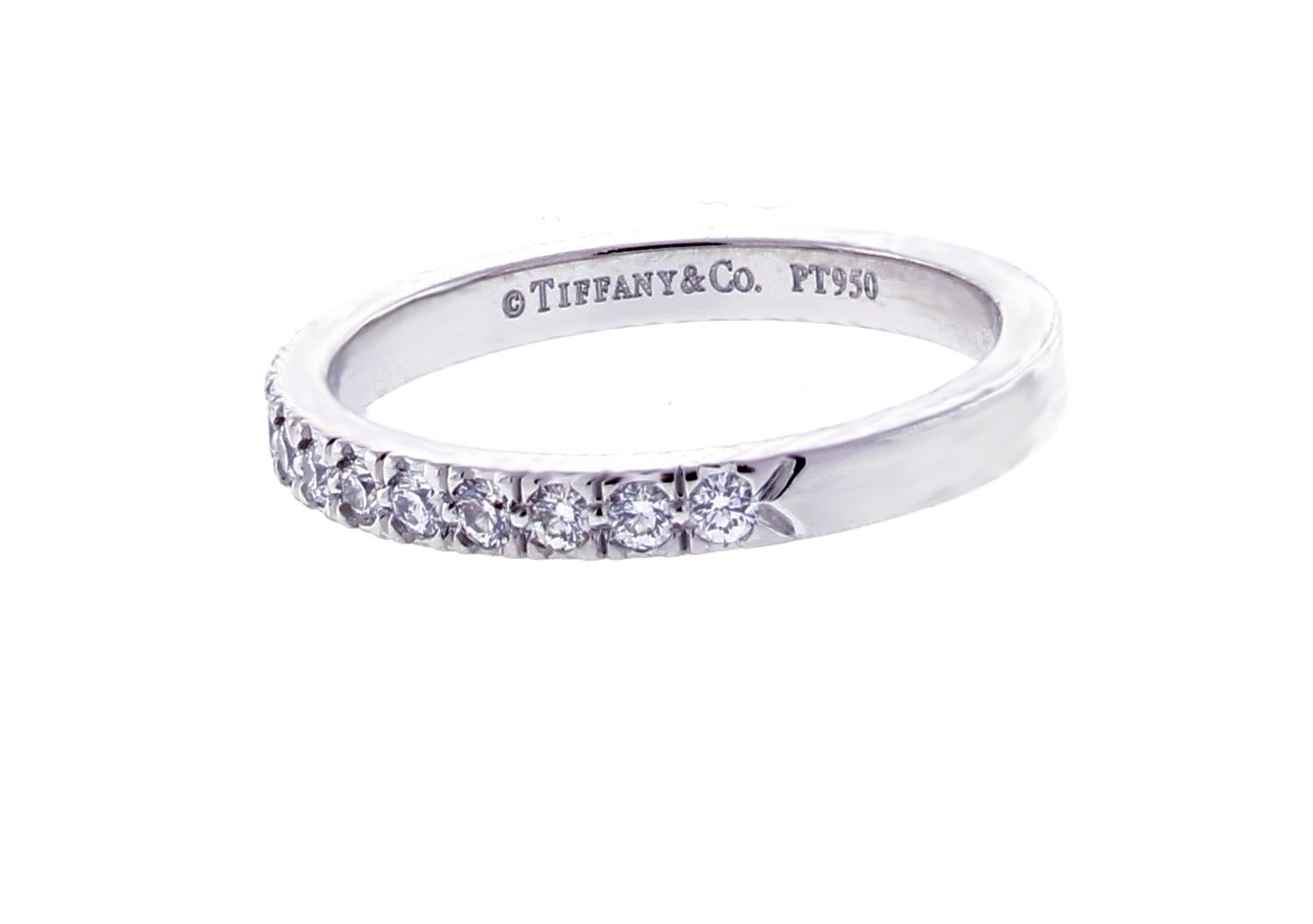 From Tiffany & Co.'s Soleste collection a half circle of shimmering diamonds in a platinum 2mm band ring. The 16 diamonds weigh .23 carats, F-G color, VVS. Size  4¾
This Tiffany Novo ring retails for $2250