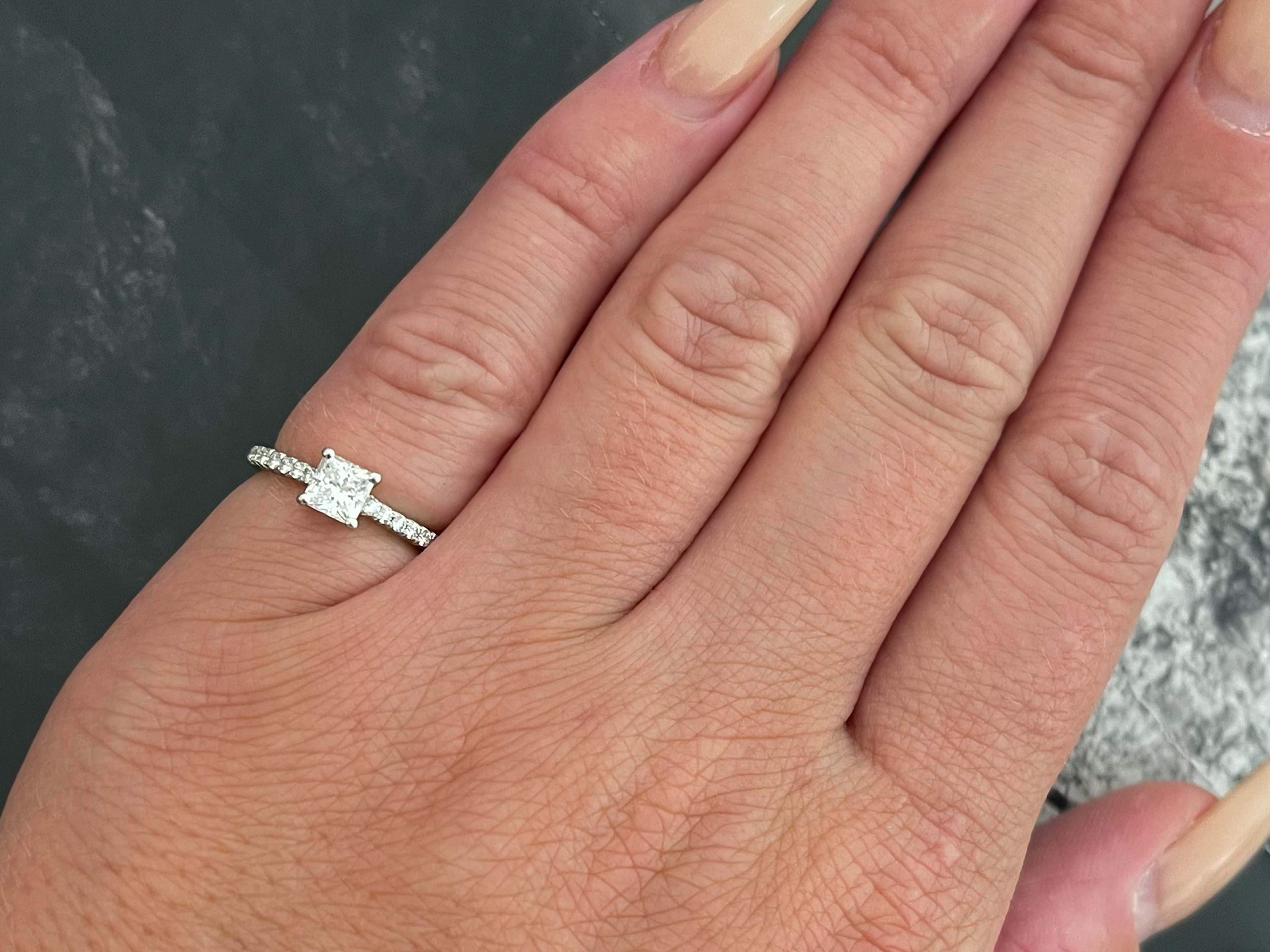 100% Authentic Tiffany & Co. novo princess cut engagement ring with a 0.51 carat excellent cut diamond center, the diamond color grade is G, and clarity is VVS1. The diamond is set in 4 prongs and has a pave diamond platinum band. The ring comes