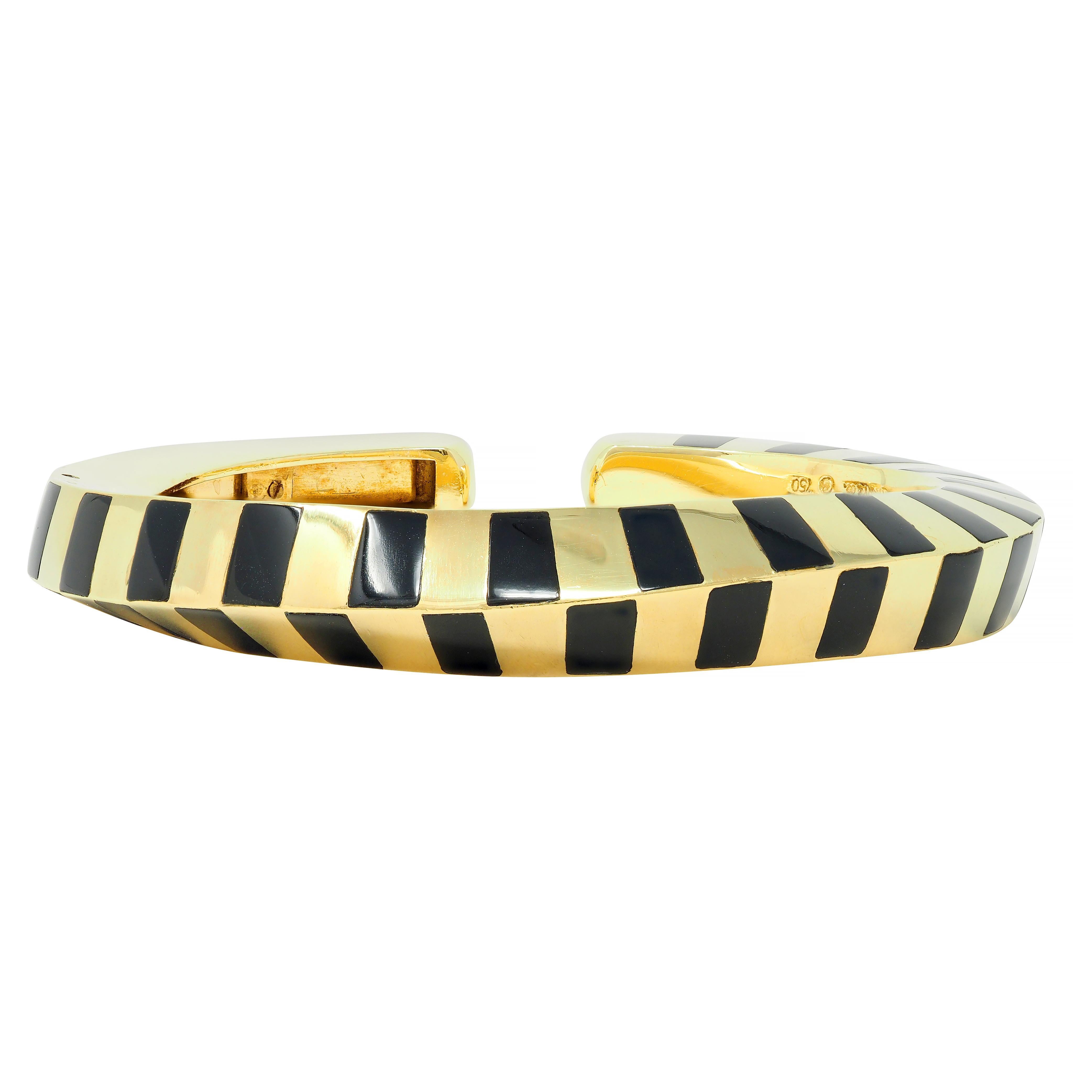 Designed as a faceted and slightly twisted gold cuff 
Accented by an inlaid onyx plaque stripe motif
Opaque glossy black in color 
Terminals are rounded - one is hinged for easy wear
Stamped for 18 karat gold
Fully signed for Tiffany & Co.
Circa: