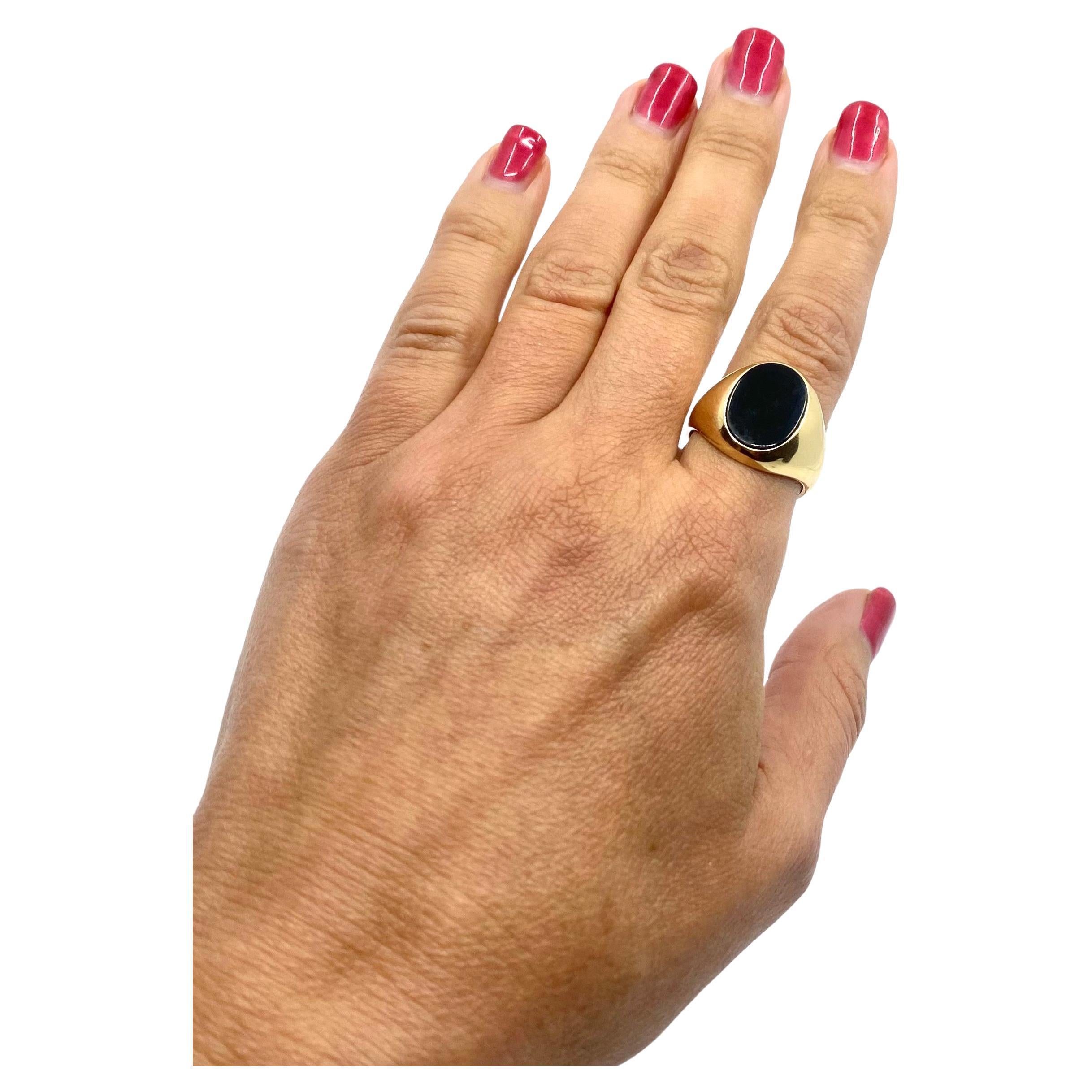 A vintage 14k gold signet ring featuring onyx. It’s a unisex ring with an oval face.
Polished satin black gemstone is perfectly framed with a massive gold shank. The
gold has a nice hue that is close to white gold, which works great with the