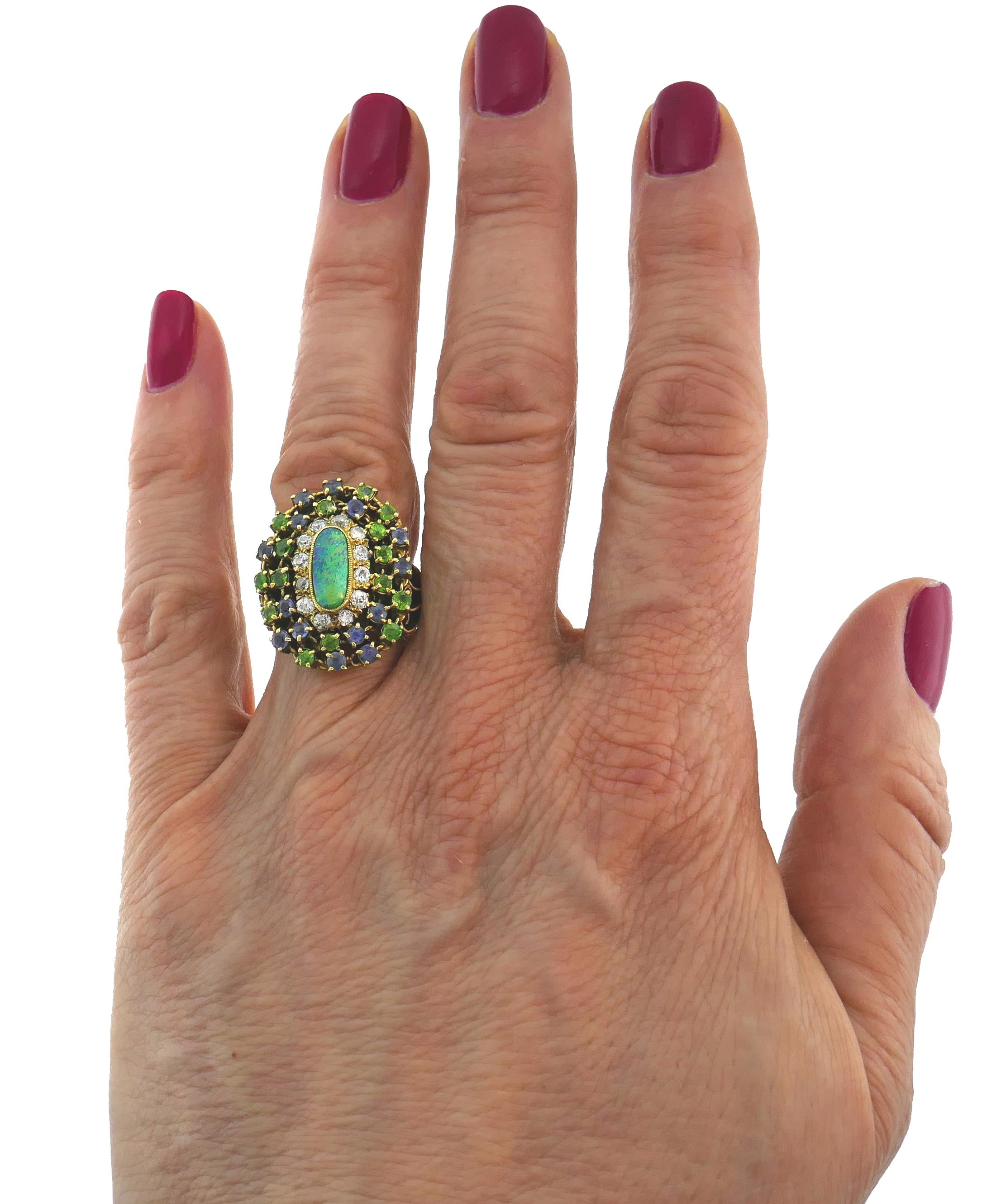 Beautiful rare ring created by Tiffany & Co. in the late 1960s. Elegant and timeless, the ring is a great addition to your jewelry collection. 
The ring features a lovely elongated opal framed by a row of 12 Old European cut diamonds and two rows of