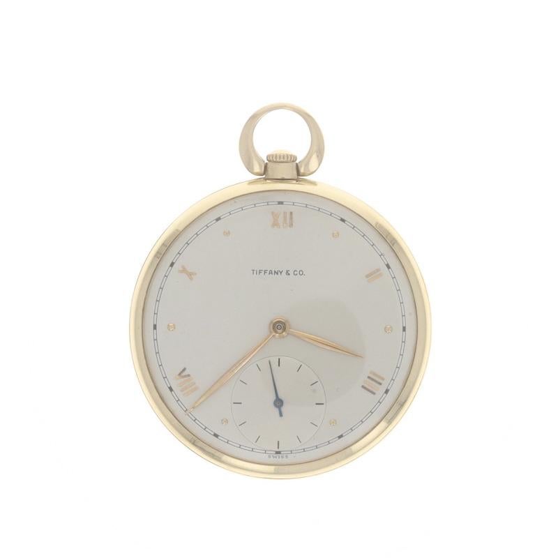 Brand: Tiffany & Co.
Movement: Mechanical
Movement Maker: Swiss
Dial Color: Silver

Metal Content: 14k Yellow Gold

Style: Open Face
Features: 
Roman numerals marking the 12, 2, 4, 8, and 10 o'clock hours 
Sub dial at the 6 o'clock position 
Dots