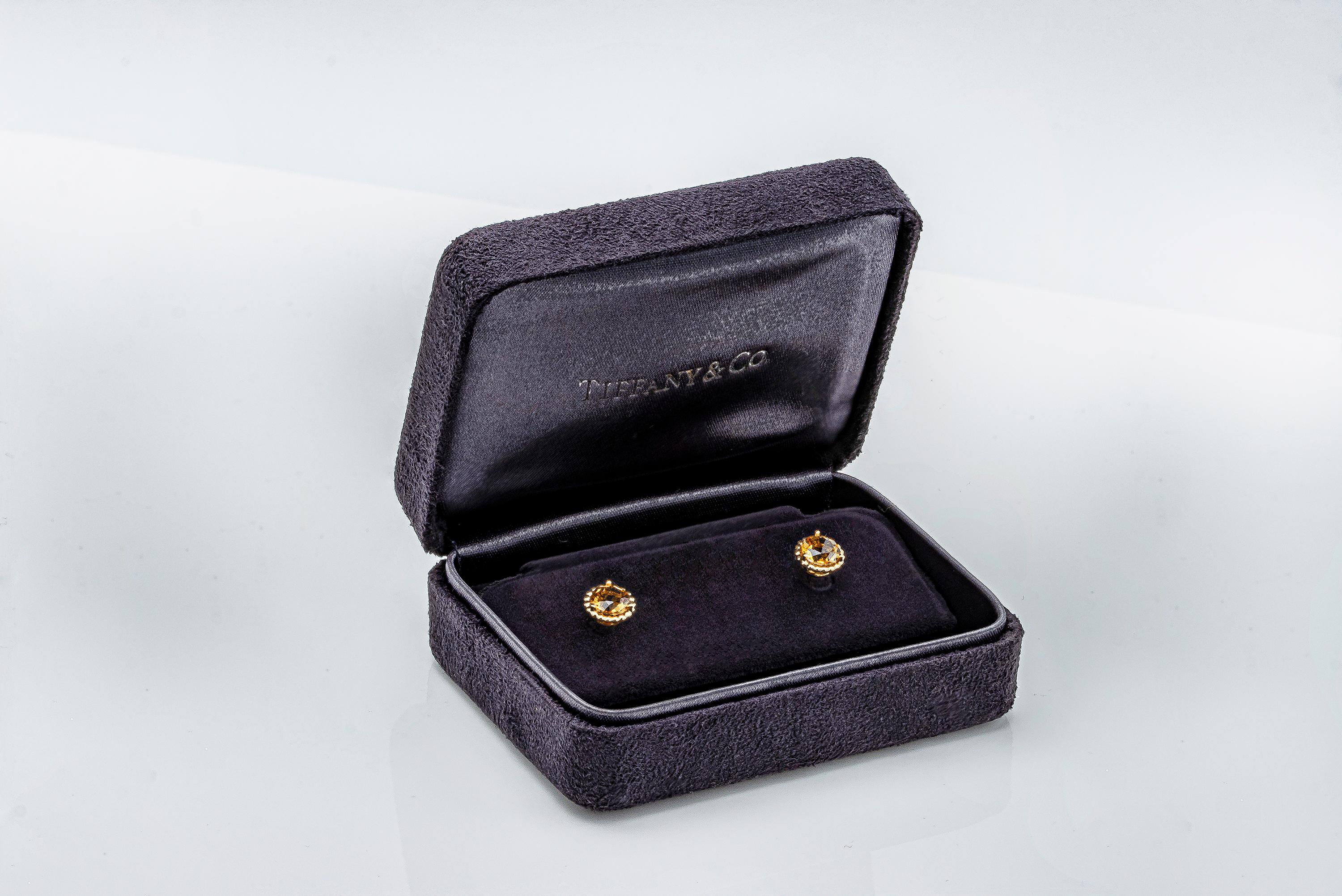 A discontinued model made and signed by Tiffany and Co. Each earring features a vibrant round orange citrine, set in a beaded style basket made in yellow gold. Comes with original Tiffany & Co. box. 