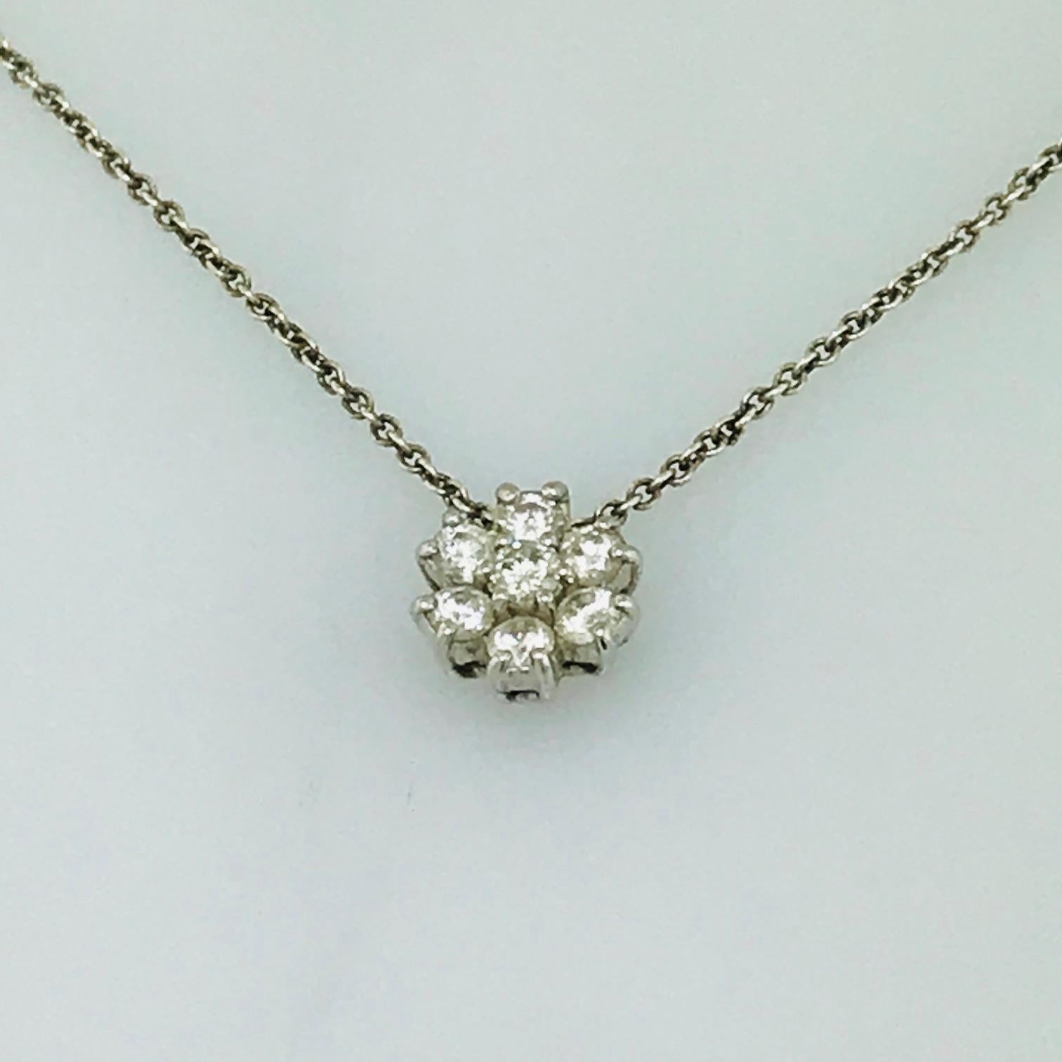 This Tiffany & Co. Diamond Necklace is an original Tiffany & Co. piece with the original Tiffany & Co. box. This sterling silver diamond cluster necklace has .30 carats total diamond weight with the round brilliant diamonds set in a flower-like