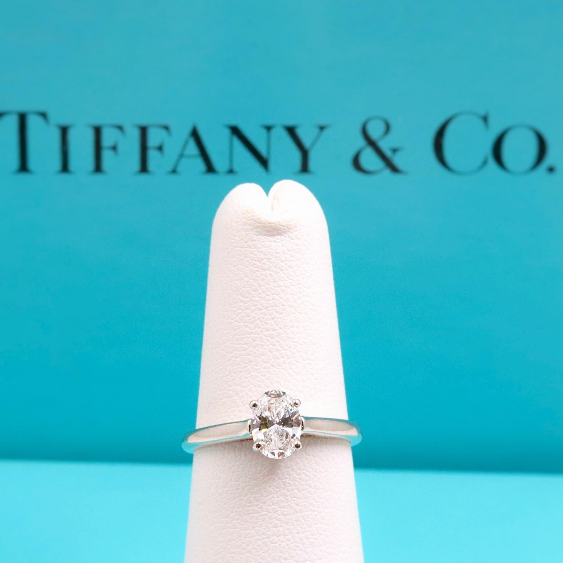 Tiffany & Co.

Style:  Classic Solitaire Engagement Ring
Serial Number: D13083
Metal:  Platinum PT950
Size:  6 - sizable
Total Carat Weight:  0.66 CTS
Diamond Shape:  Oval Shape Brilliant
Diamond Color & Clarity:  E - VVS2
Hallmark:  D13083 .66