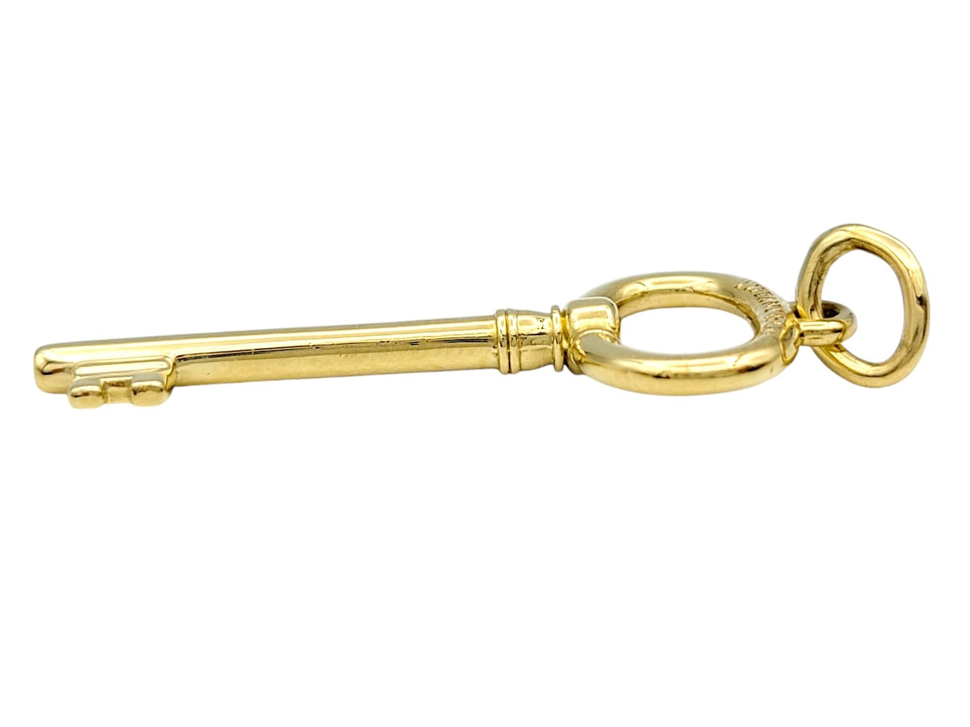 Contemporary Tiffany & Co. Oval Key Pendant / Charm in Polished 18 Karat Yellow Gold