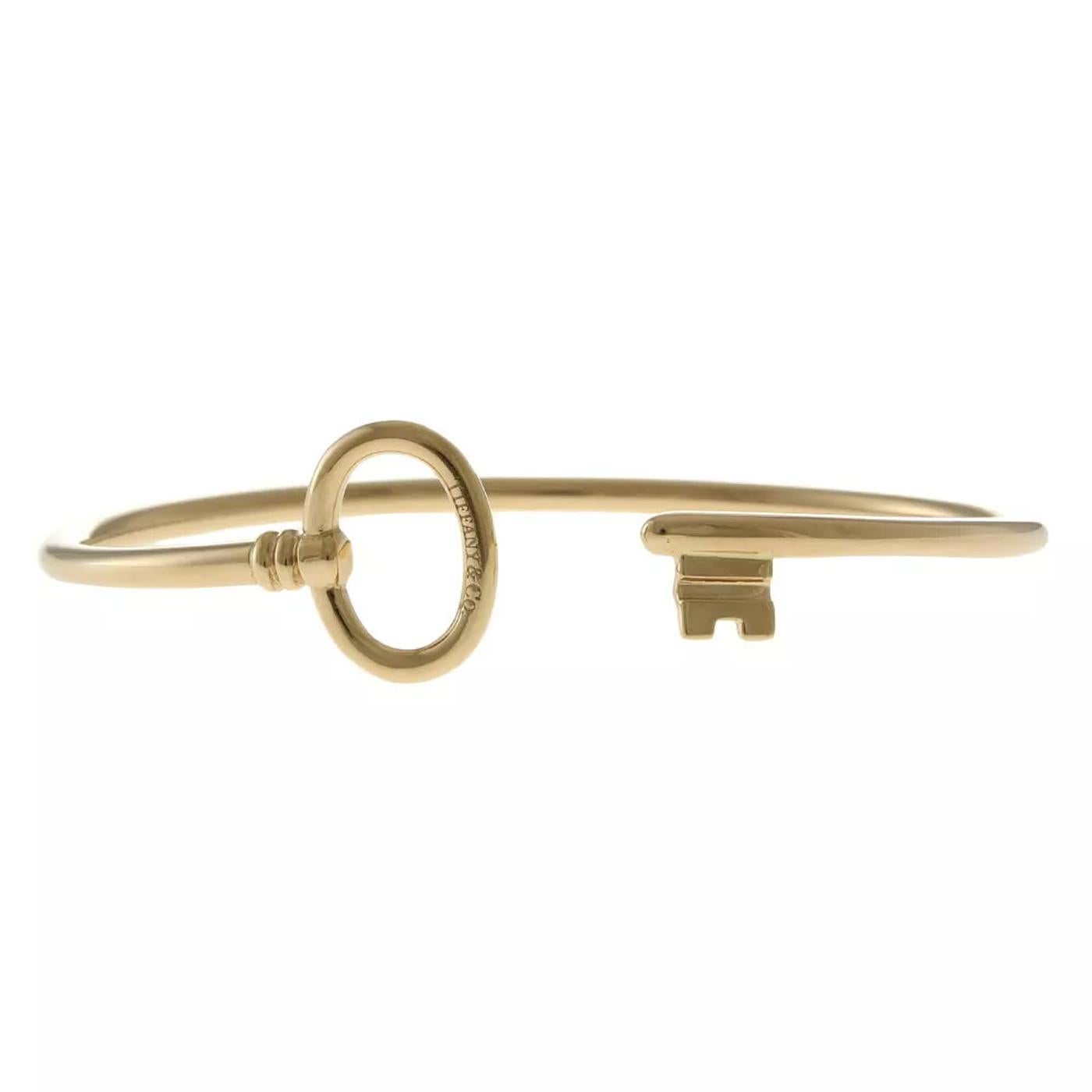 Add a touch of elegance to your look with this stunning Tiffany & Co. Key Wire Bangle. Crafted in luxurious 18K pink gold, this delicate bangle showcases the iconic Tiffany key design. Its sleek, minimalist form makes it versatile enough for daily