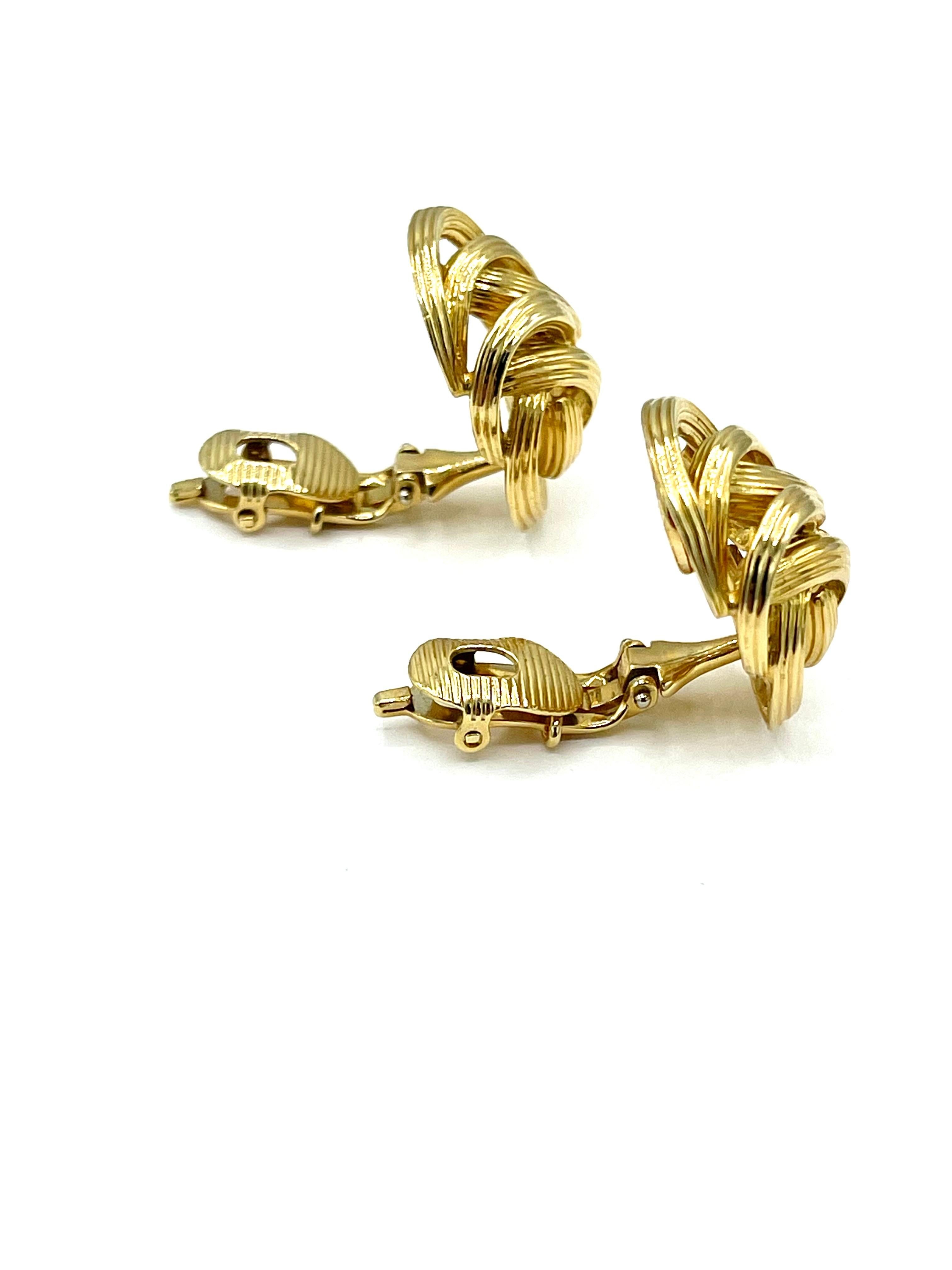 A great pair of Tiffany & Co. earrings!  These 18k yellow gold oval knot earrings are designed with textured gold and a leaver back clip.  They are signed 
