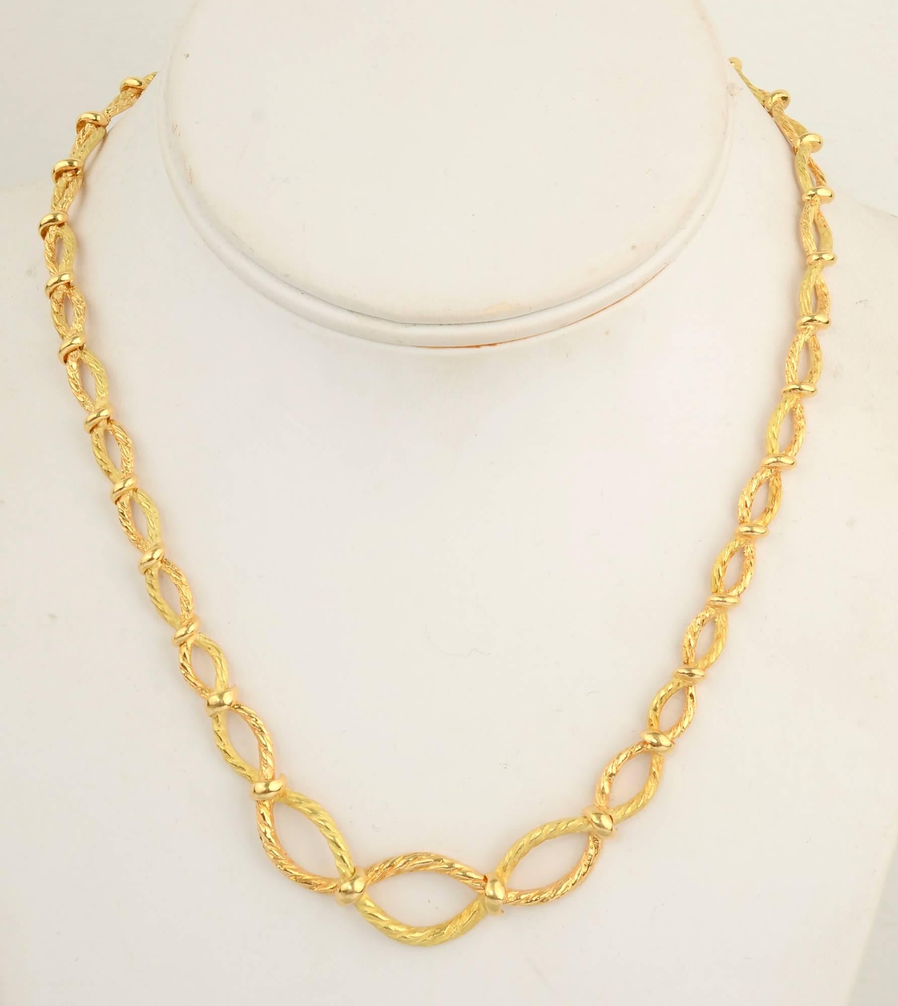 Graduated oval links make a beautiful design in this 18 karat gold necklace by Tiffany; made in France. The links are made of twisted gold with smooth intersections. The center links are half an inch wide and narrow to 1/4 inch at the clasp. Length