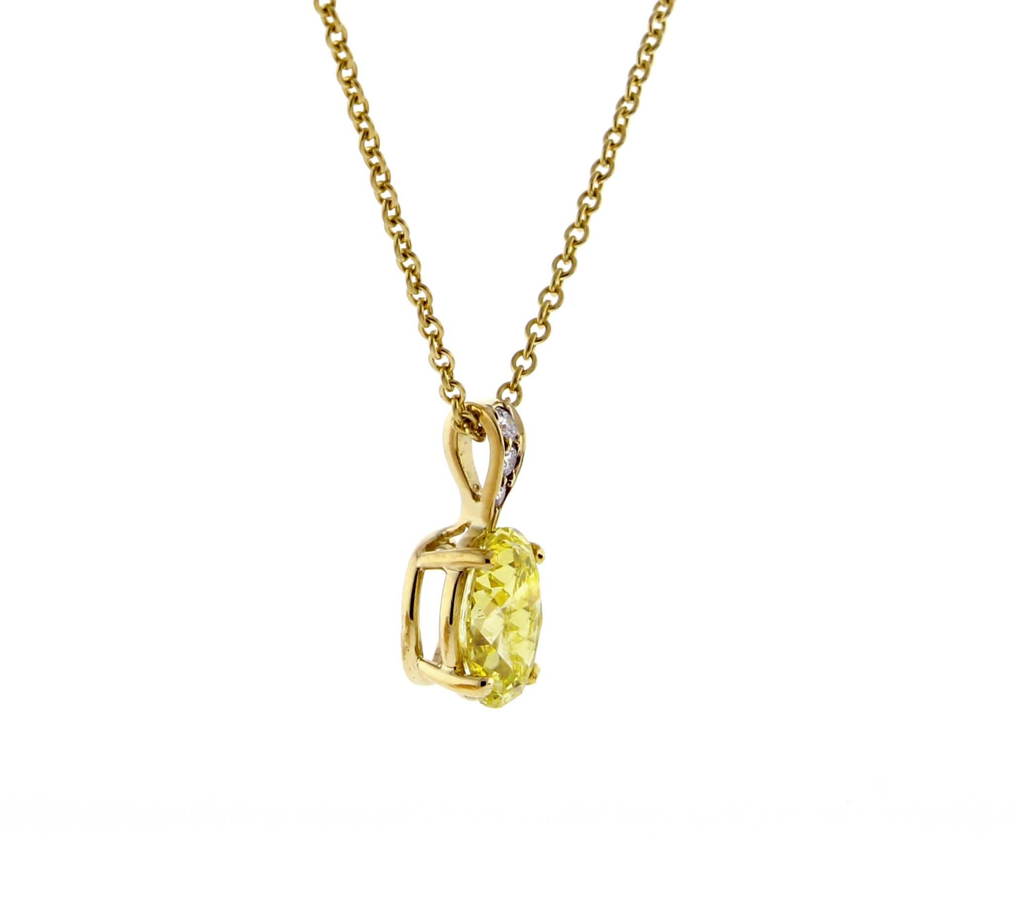 A dazzling oval Fancy Intense yellow  Tiffany diamond shines like the sun on a chain of 18 karat gold. On a 16
