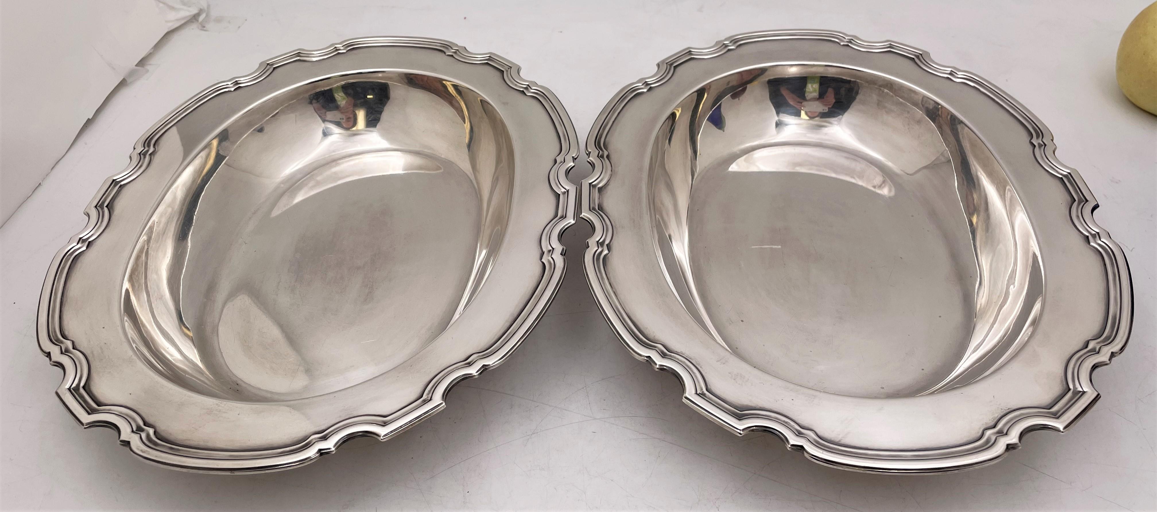 Tiffany & Co., pair of sterling silver vegetables dishes in pattern number 20346 from 1924, possibly in the Hampton pattern, and in Art Deco style with a wide-shaped, geometrically inclined, curvilinear rim. Each measures 11 1/2'' in length by 9