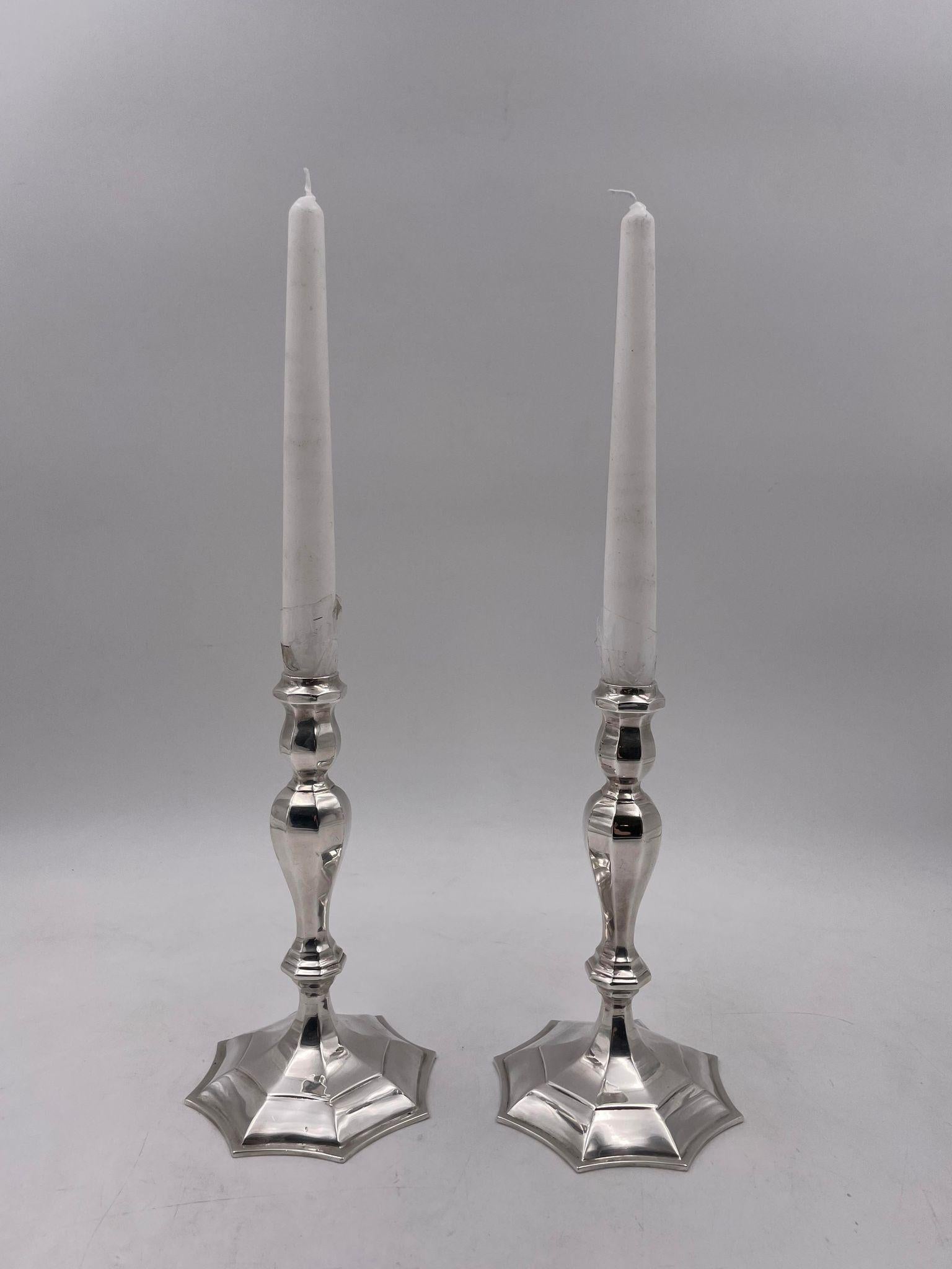 Tiffany & Co. pair of two rare English-made sterling silver candlesticks (h 7.5 in; w 4.5 in) from 1959. They are in a Mid-Century Modern style with a beautiful geometric design. Total weight is 21.2 ozt. 

Founded in 1837 by Charles Lewis Tiffany
