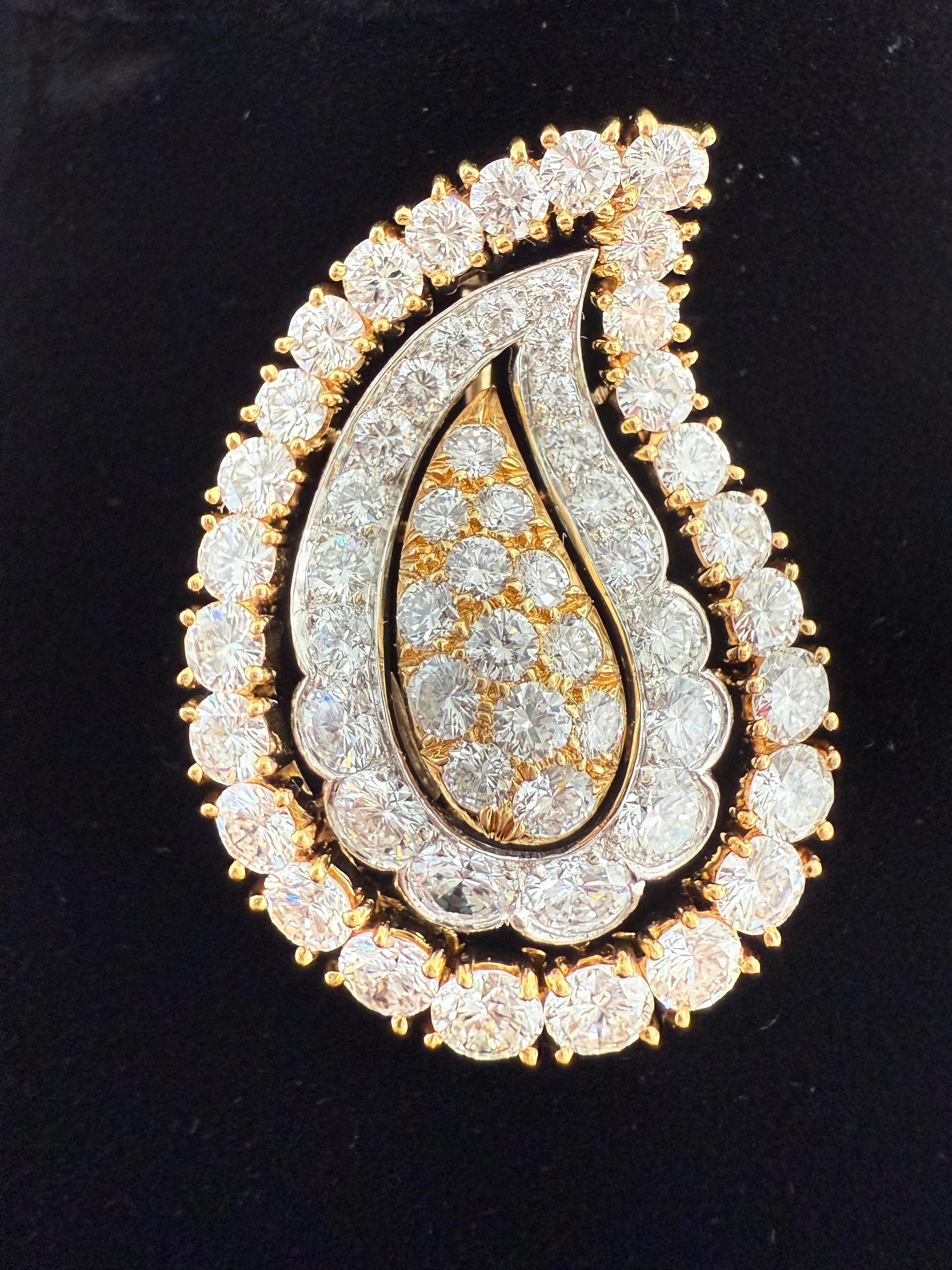 Tiffany & Co 
Diamond Brooch Paisley motif. 60 Beautiful fine round diamonds F color VVS Quality set an 18 karat gold and platinum approximately one and a half inches in length and one inch in width Hallmark Tiffany and Company 18 karat and