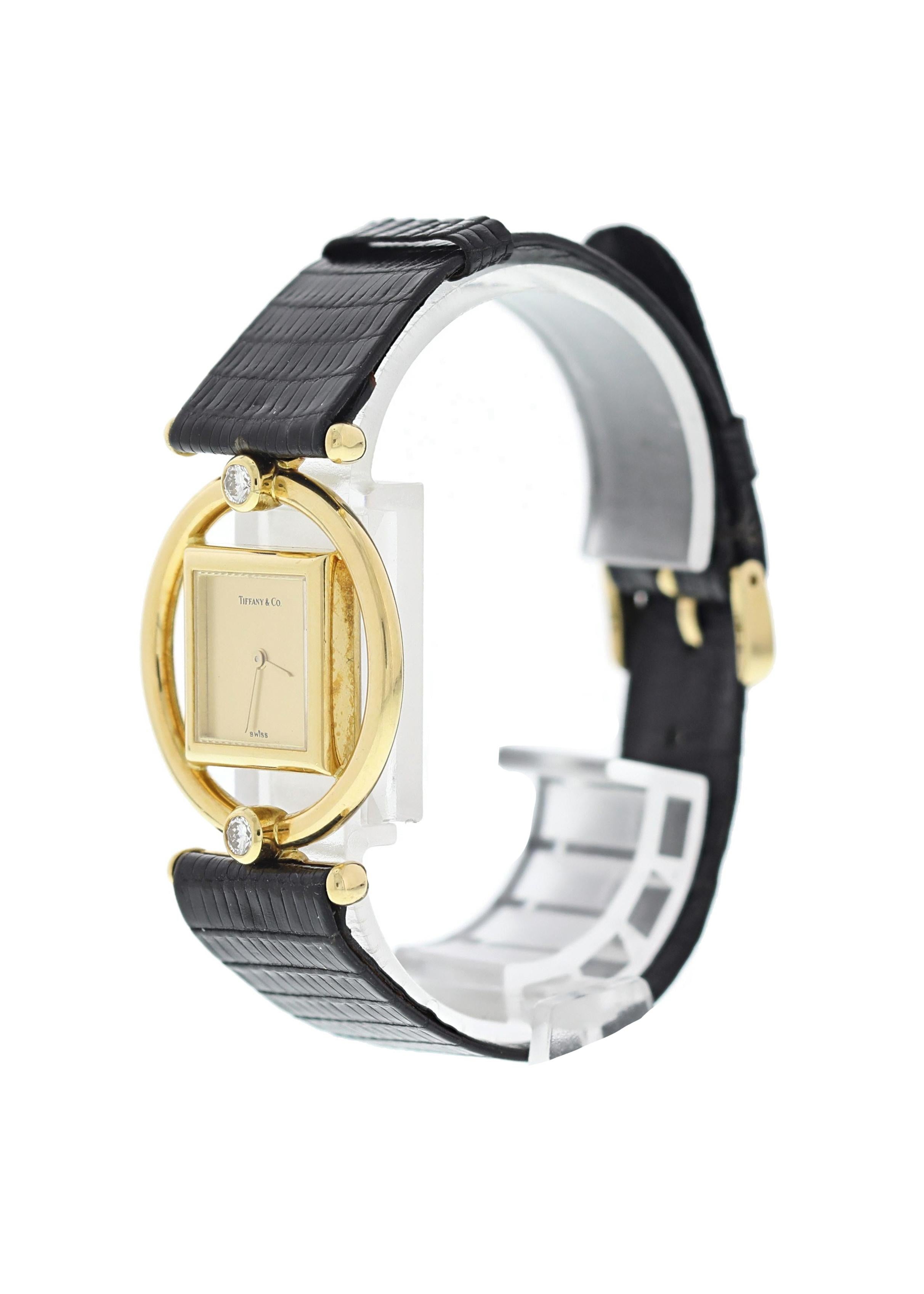Tiffany & CO. Paloma Picasso 18k Yellow Gold Ladies Watch. 30mm 18k yellow gold round outer case with a 17.5mm inner floating square case. Factory set diamonds at the 6 and 12 o'clock position. Champagne dial with gold hands. Black lizard leather