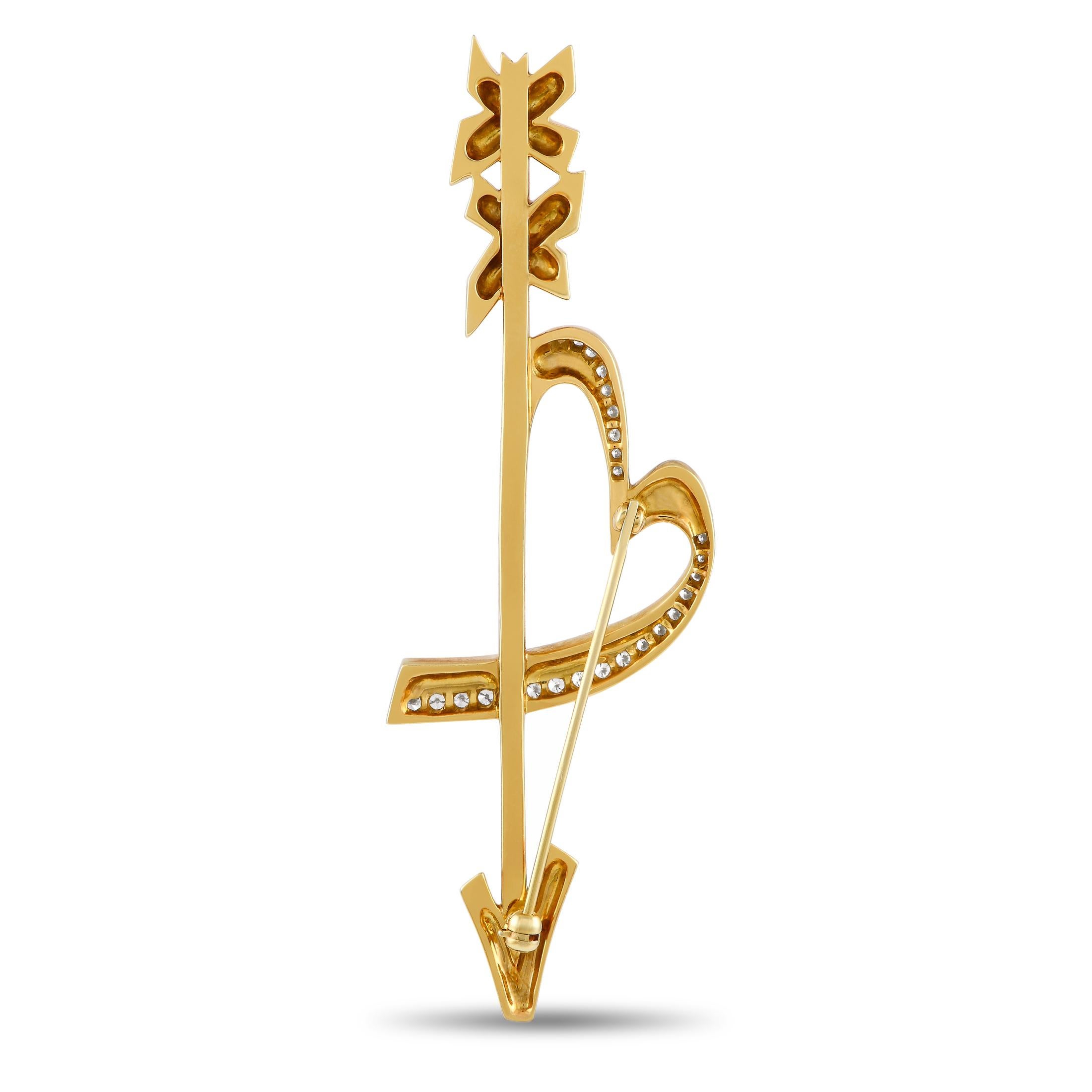 For the romantic fashionista. This heart and arrow brooch, rendered in solid 18K yellow gold, is designed by Paloma Picasso for Tiffany & Co. Inspired by cupid's arrow, this brooch captures hearts with its distinct look and sweet sparkle.This signed