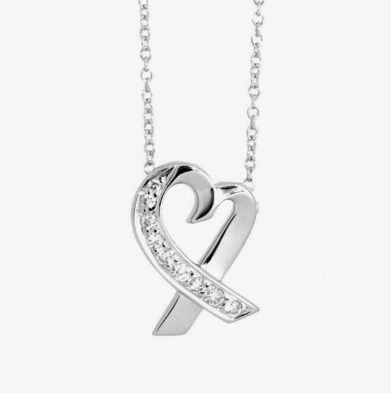 TIFFANY & Co. Paloma Picasso Collier pendentif cœur aimant en or blanc 18K et diamants

Métal : or blanc 18K 
Chaîne : 16