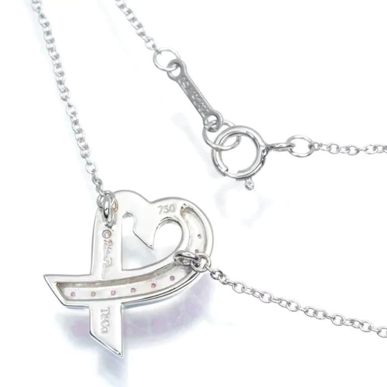 TIFFANY & Co. Paloma Picasso 18K White Gold Pink Sapphire Loving Heart Necklace In Excellent Condition For Sale In Los Angeles, CA
