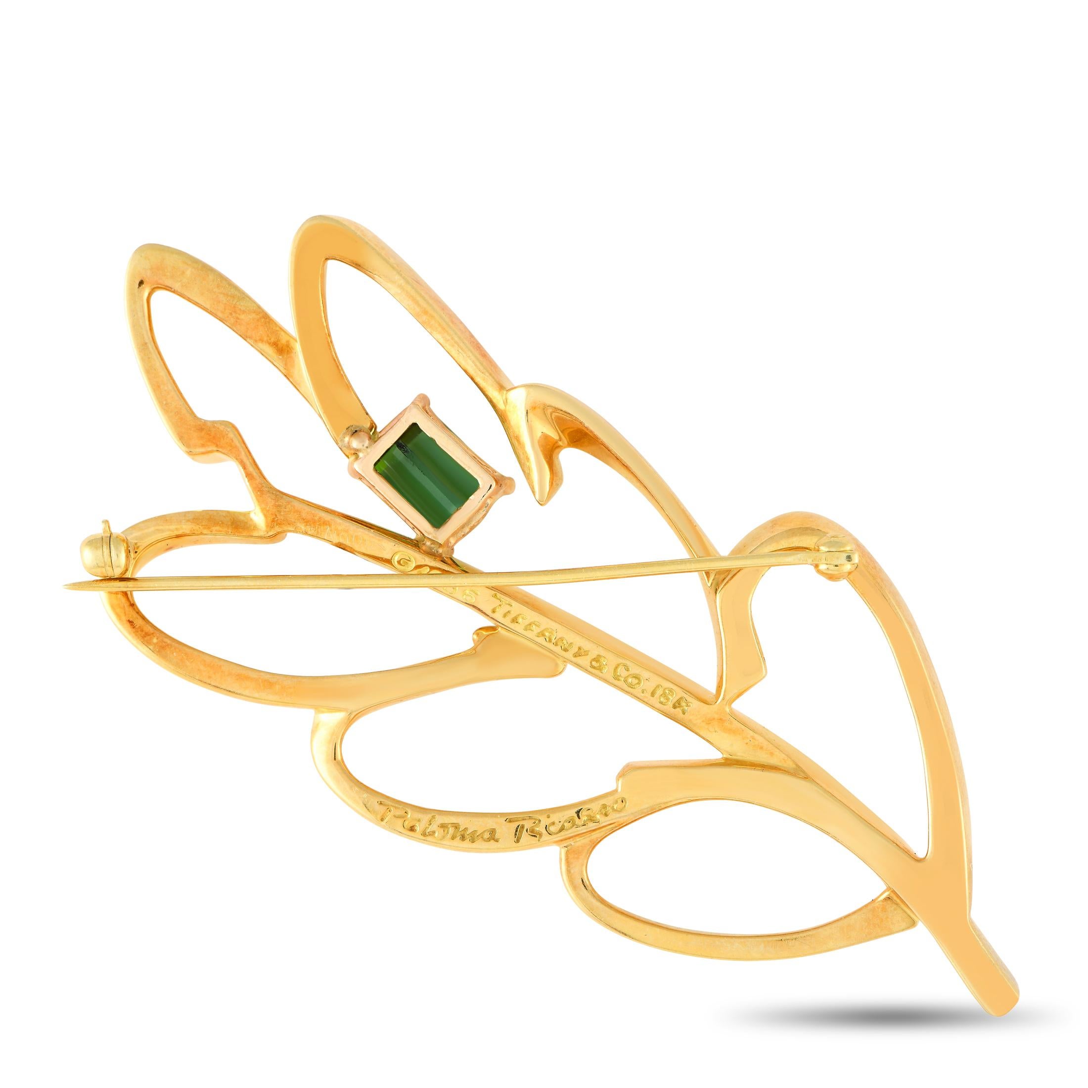 This Tiffany & Co. Paloma Picasso brooch is ideal for anyone with a minimalist aesthetic. Sleek and delicate, the leaf-shaped design is crafted from 18K yellow gold and includes a single tourmaline gemstone accent. It measures 2.25” long by 2.25”
